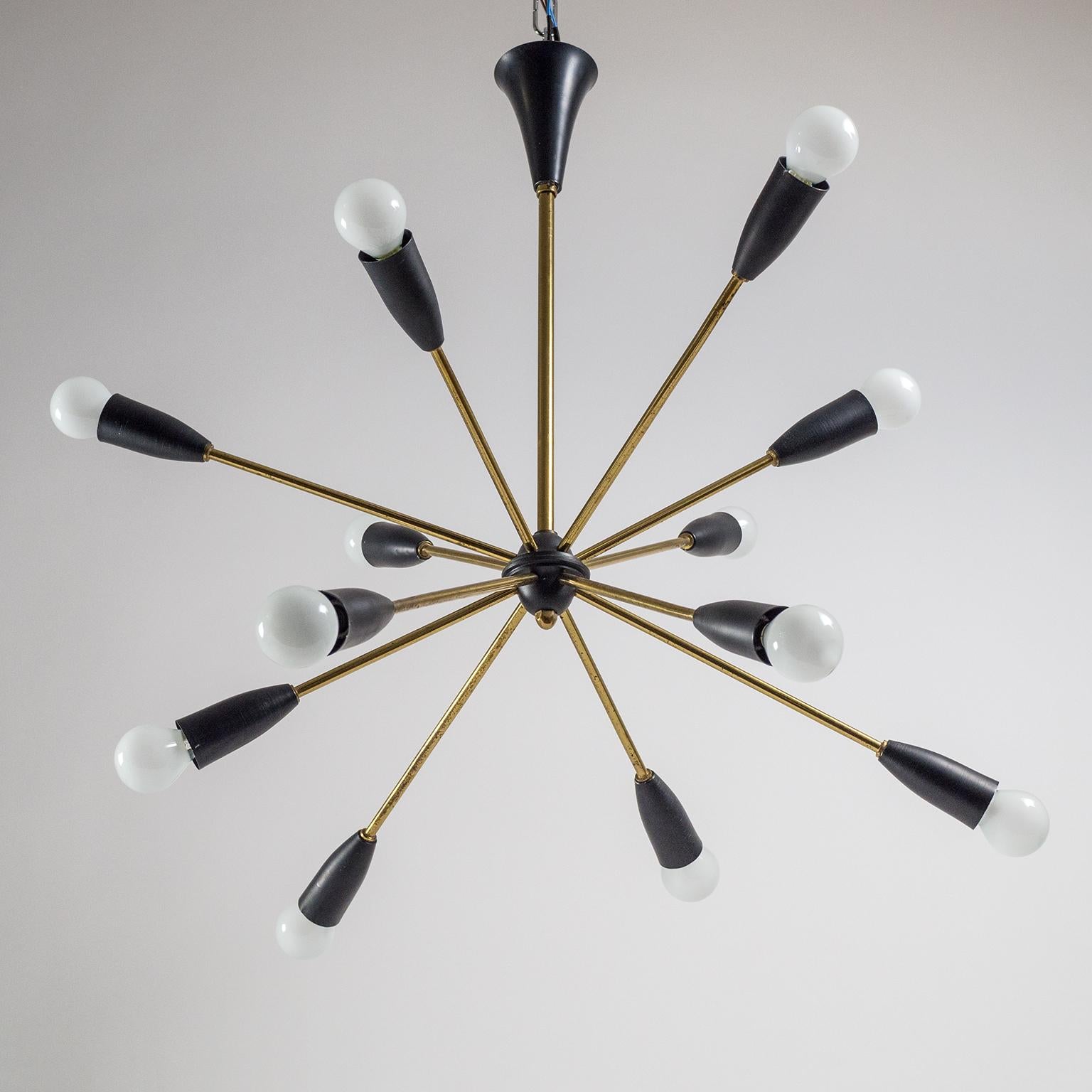Rare French Sputnik chandelier from the 1950s. Twelve brass arms in two different lengths give this chandelier an wonderful mid century asymetric 'star burst' touch, changing its appearance depending on the viewing angle. Lovely original condition