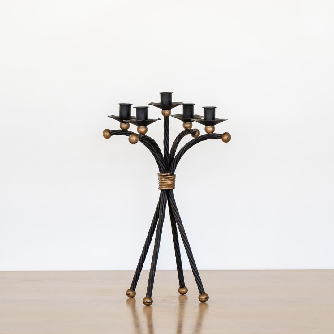 Incredible vintage iron five arm candelabra in the style of Jean Royere from France, 1950's. Black twisted iron with five curved arms and four leg iron base and gold painted ball detailing. Great age and patina to finish