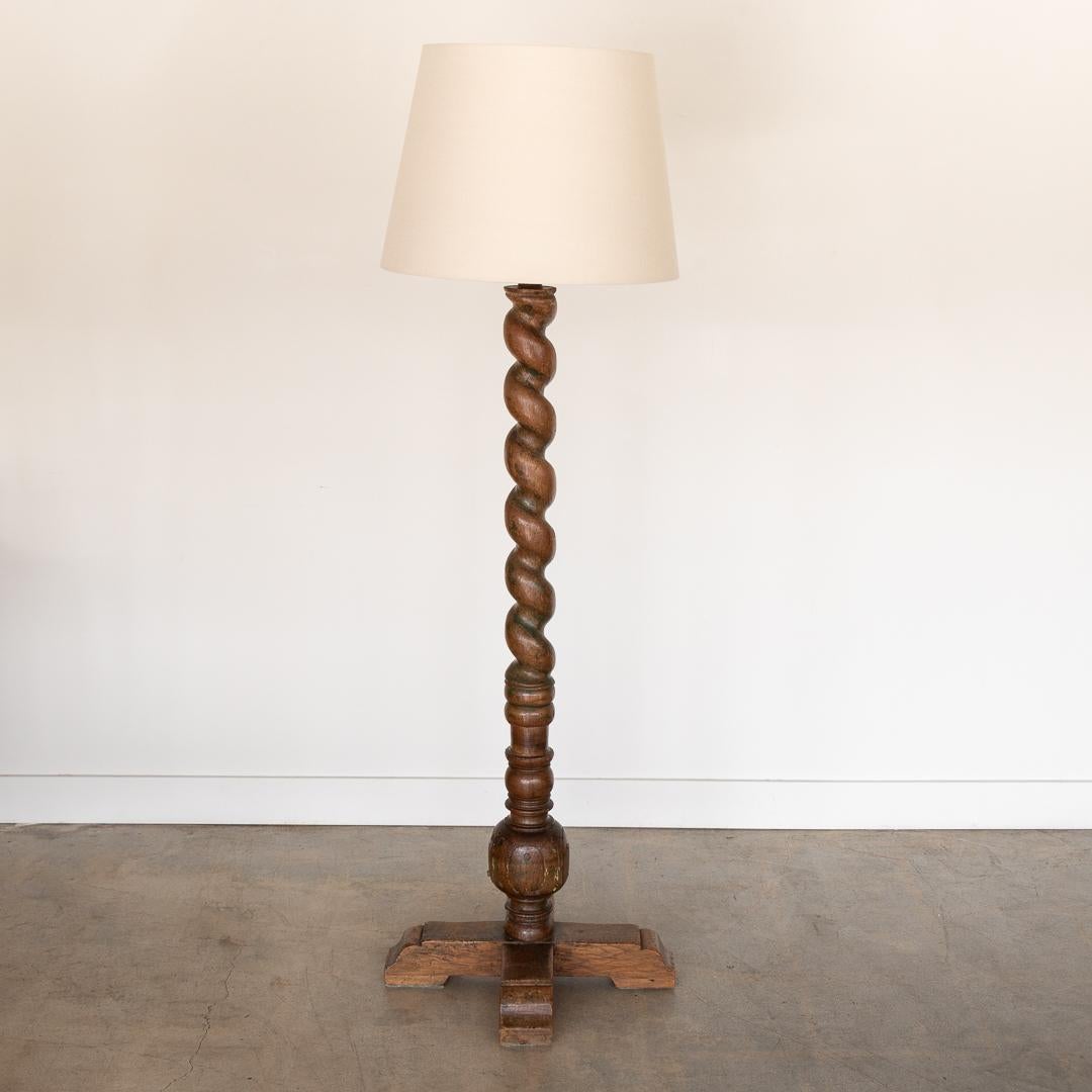 Wonderful vintage twisted wood floor lamp from France, 1940's. Large twisted wood stem and cross base. Original finish shows wonderful age and patina. Natural cracks in wood add great character. Newly re-wired with exposed brown cloth cord running