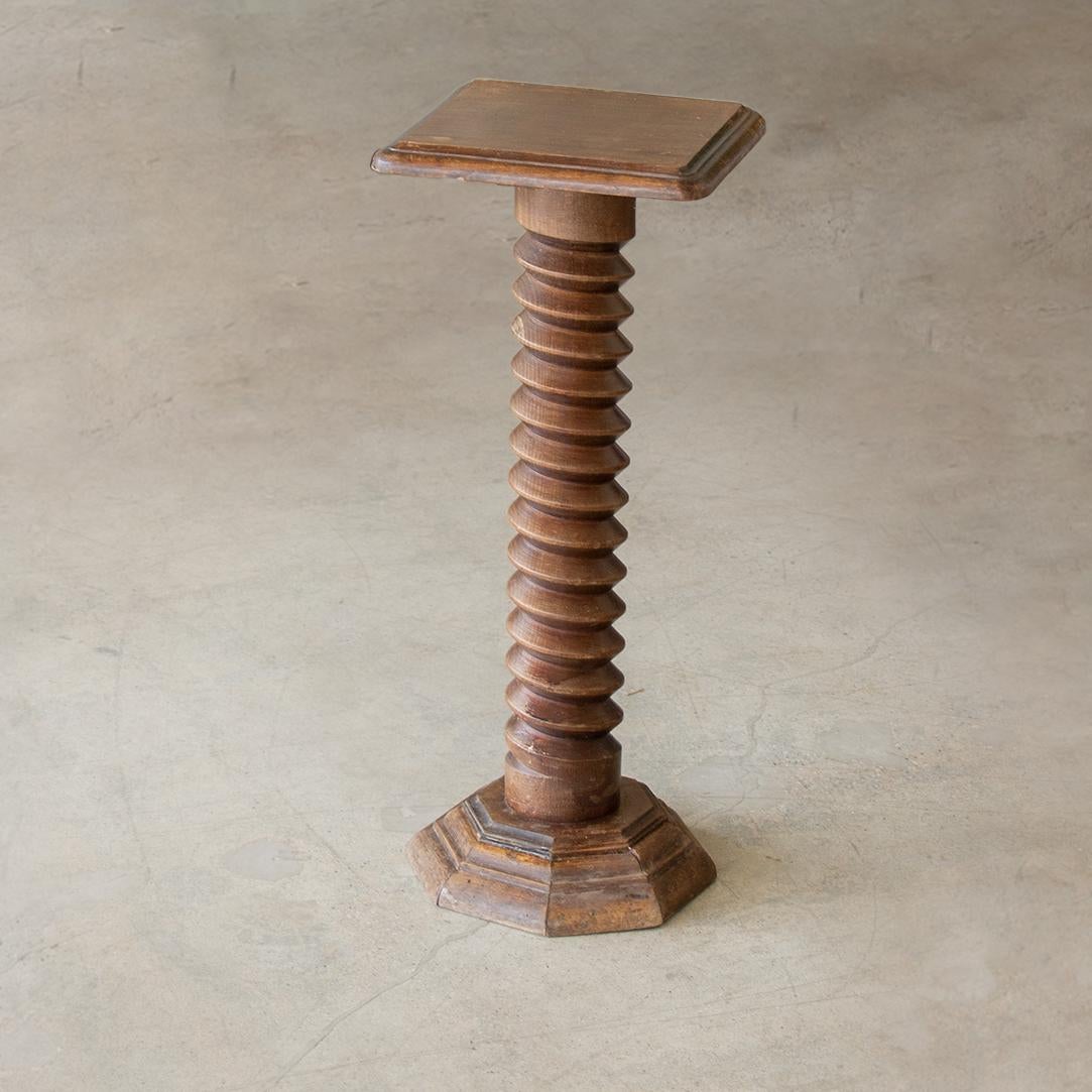 Unique twisted wood pedestal table from France. Original wood finish with twisted twirl wood stem and square top.
