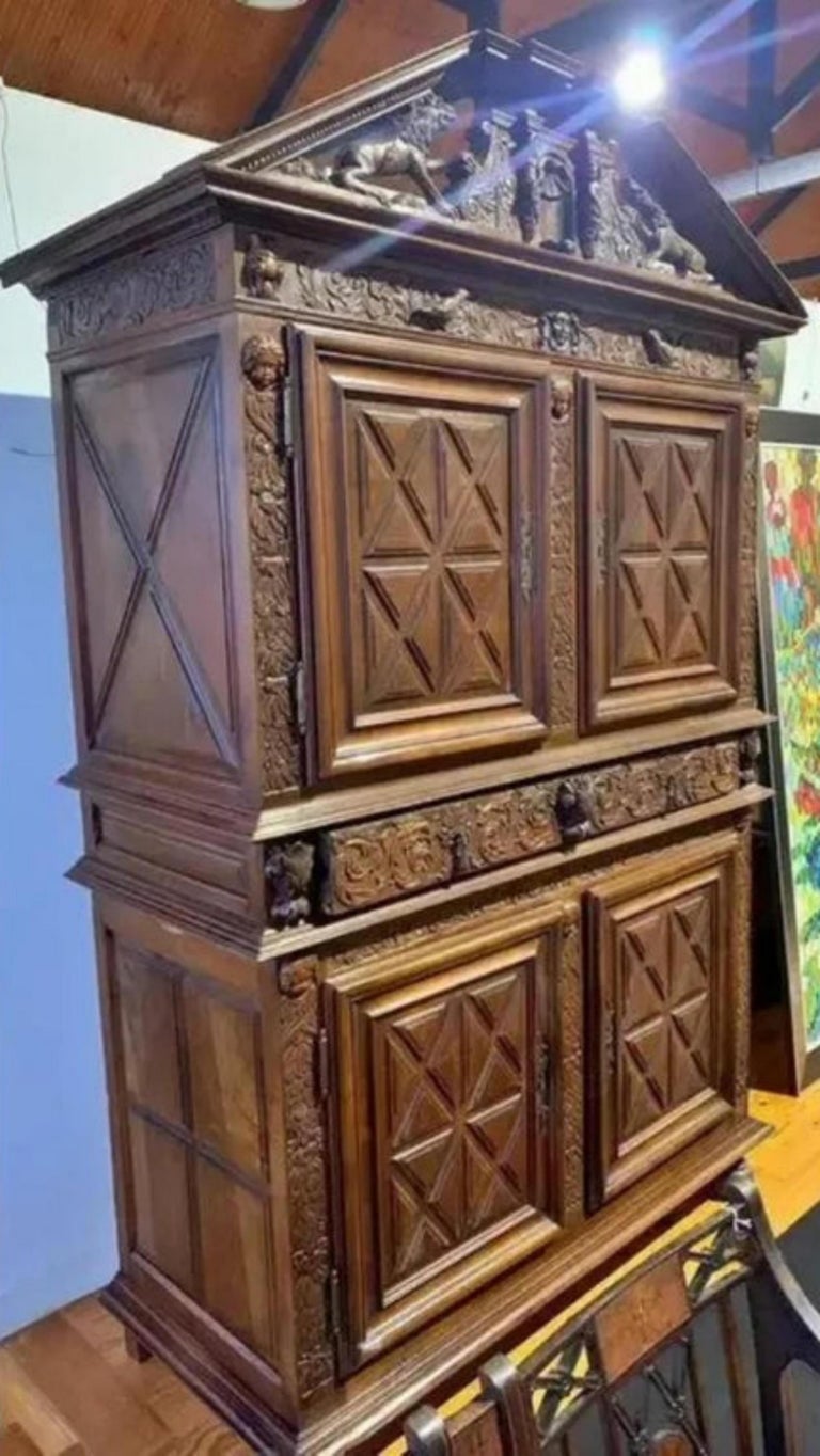 Title: French two-section cabinet.
Date/Period: 18th century.
Dimension: 248 x 146 x 66 cm.
Materials: carved oak and other woods.
Additional information: 18th century, in carved oak and other woods. Protruding shield decorated with plant and