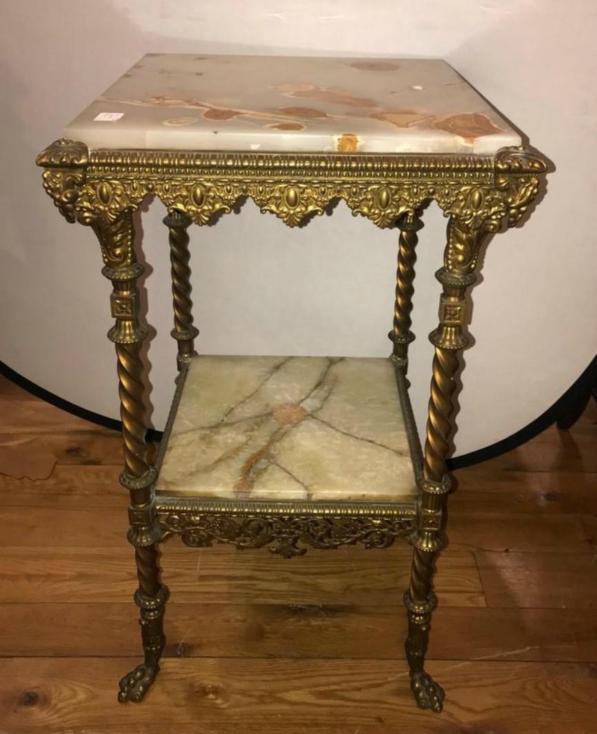 A two-tier bronze and alabaster pedestal or end table. This fine pedestal table is wonderfully case in bronze with alabaster shelves.