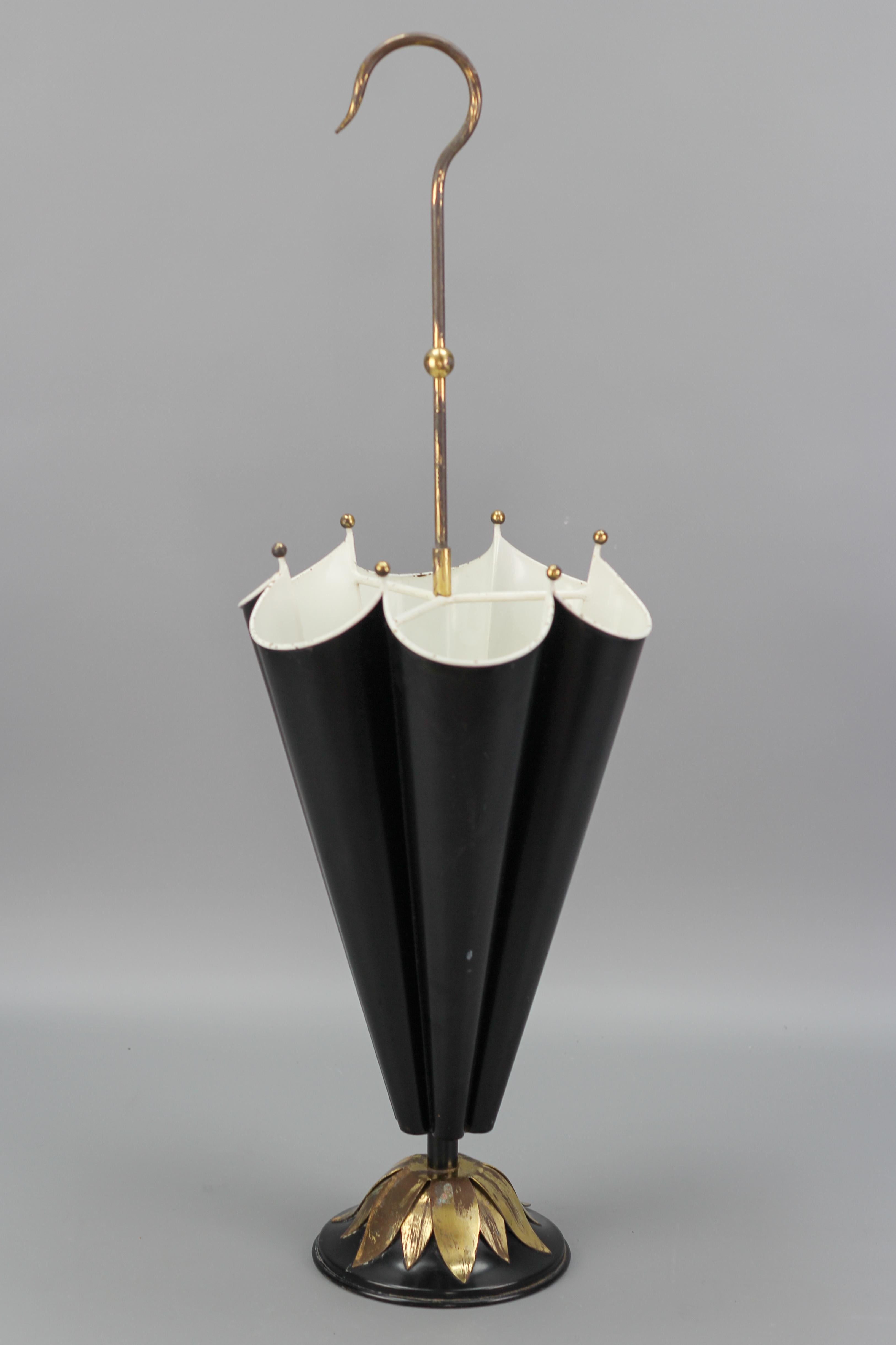 French Umbrella-Shaped Black and White Metal and Brass Umbrella Stand from the circa 1950s.
An elegant Mid-Century Modern black and white painted metal umbrella stand in the shape of an umbrella with beautiful brass details. 
Dimensions: height: