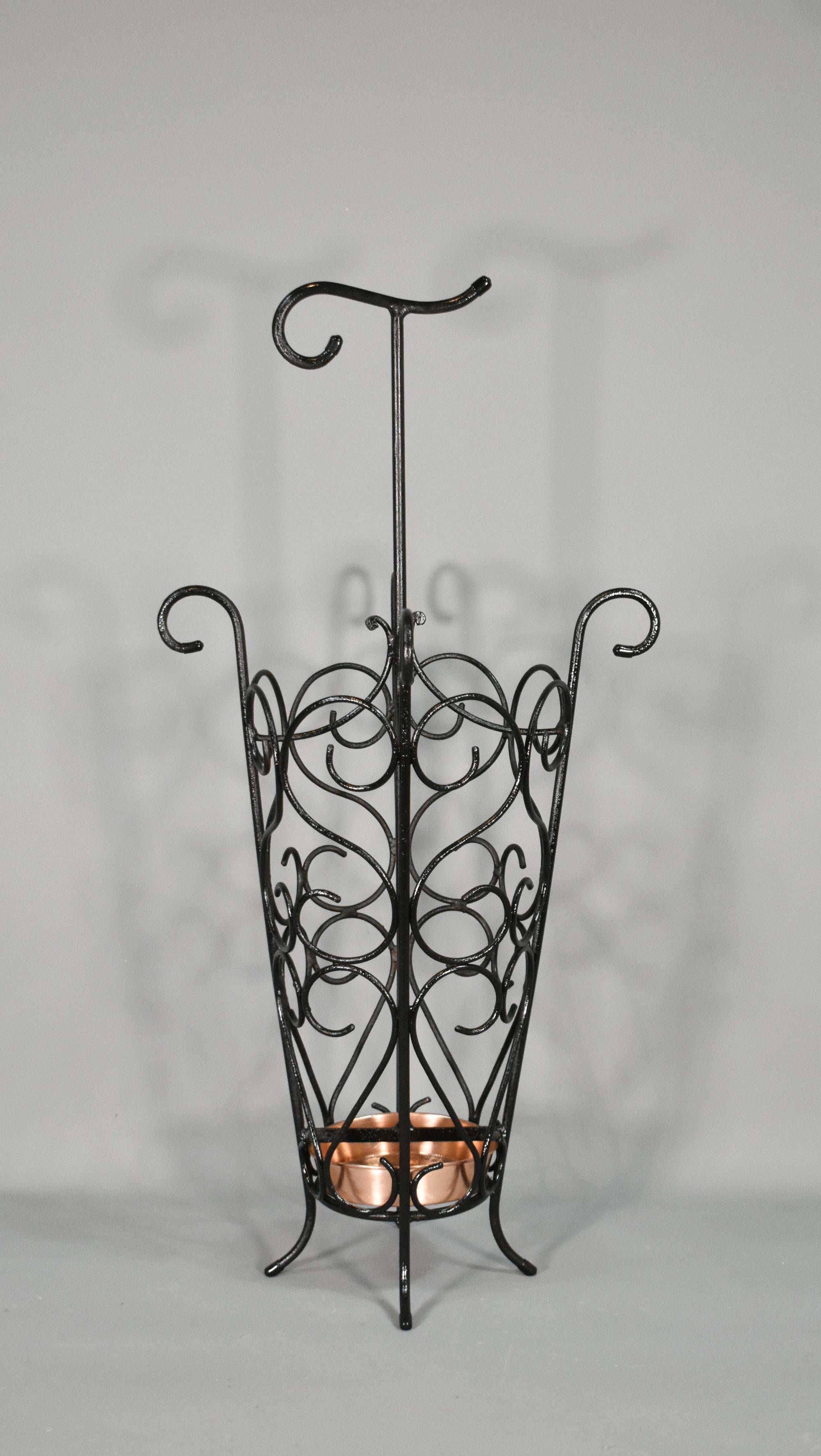 French Umbrella Stand in Wrought Iron 1950s 

A stylish and attractive French Umbrella Stand dating from the 1950s. 

It has been hand-made in wrought iron with a C scroll framework and stands on gently out-swept legs with a  drip pan in polished