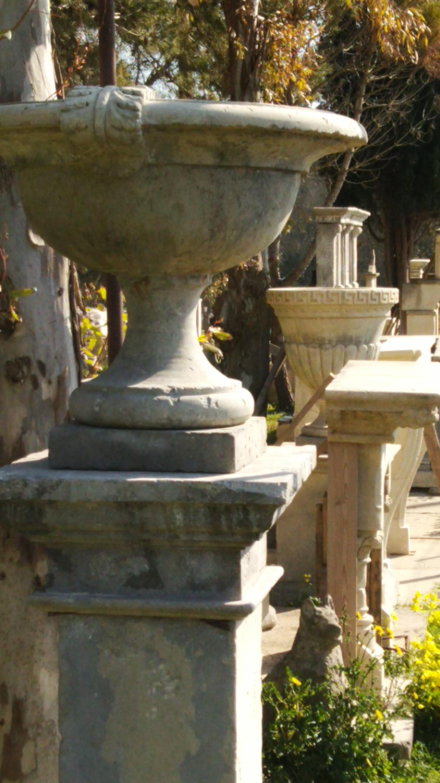 French Urns with Pedestals 'Pair' Hand-carved in Pure Limestone, antique finish. In Good Condition For Sale In LOS ANGELES, CA
