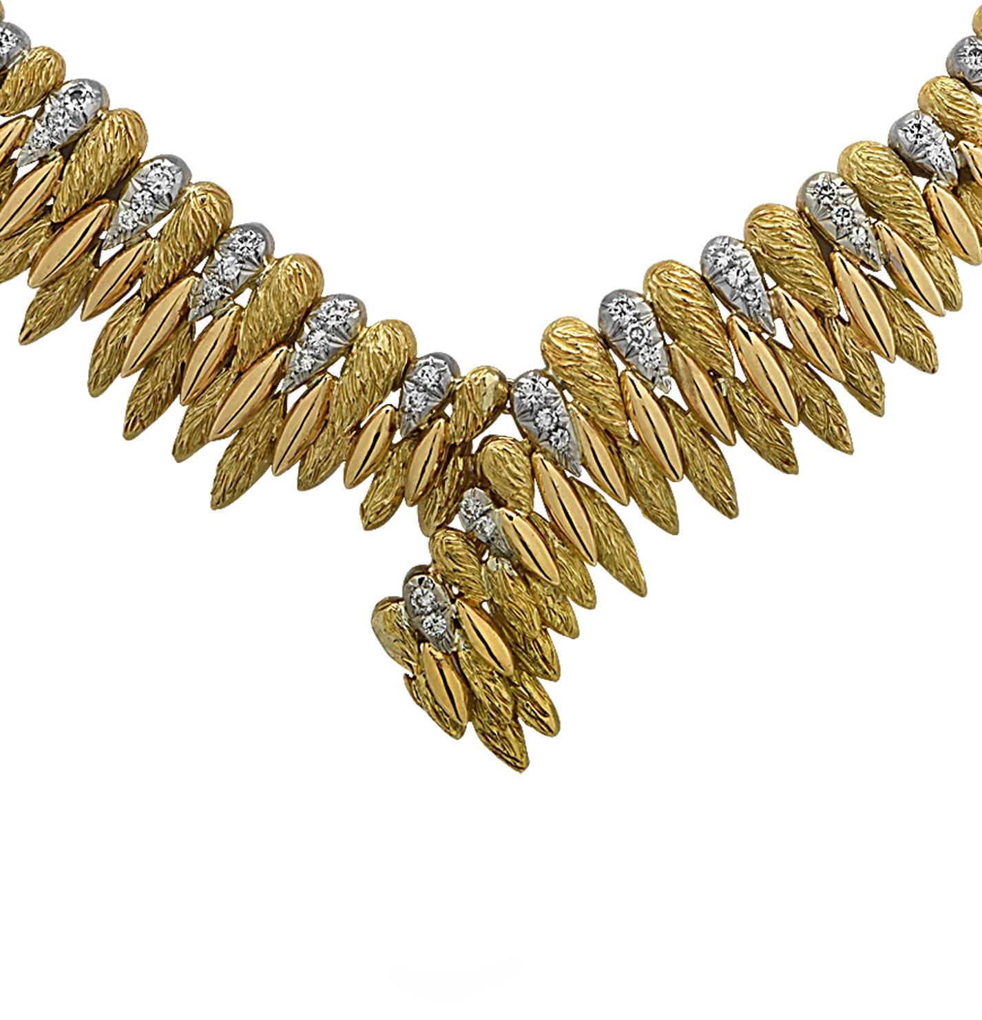 Finely crafted in France, this stunning 18 karat white and yellow gold v-shaped necklace features 54 round brilliant cut diamonds weighing approximately 1.35 carats total, G color, VS-SI clarity. Textured yellow gold beads, highly polished yellow