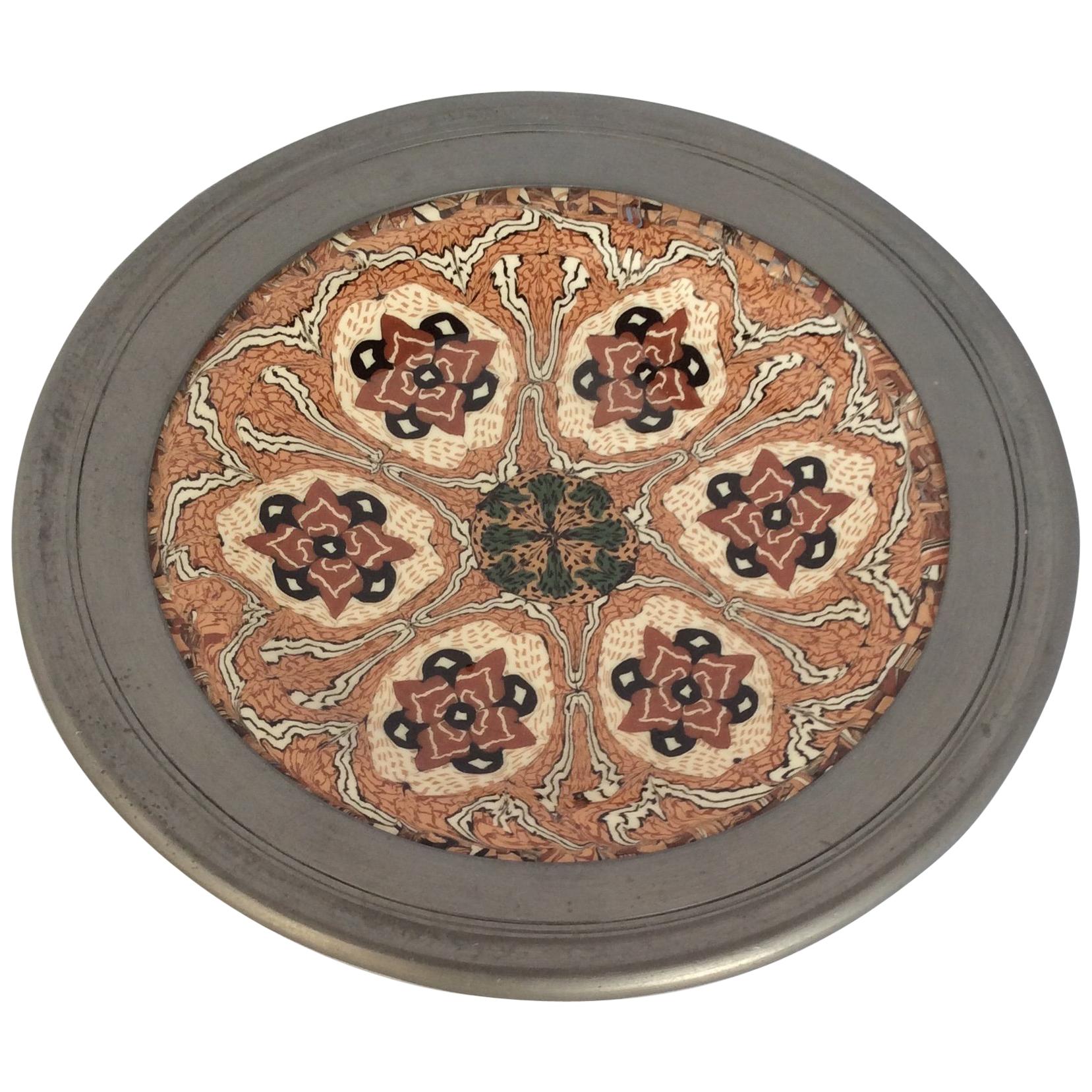 This beautiful decorative plate is made by Master Ceramicist Jean Gerbino who mastered the mosaic clay technique like no other pottery artist of his time. The outer edges of the plate is covered with pewter and can be removed. The condition