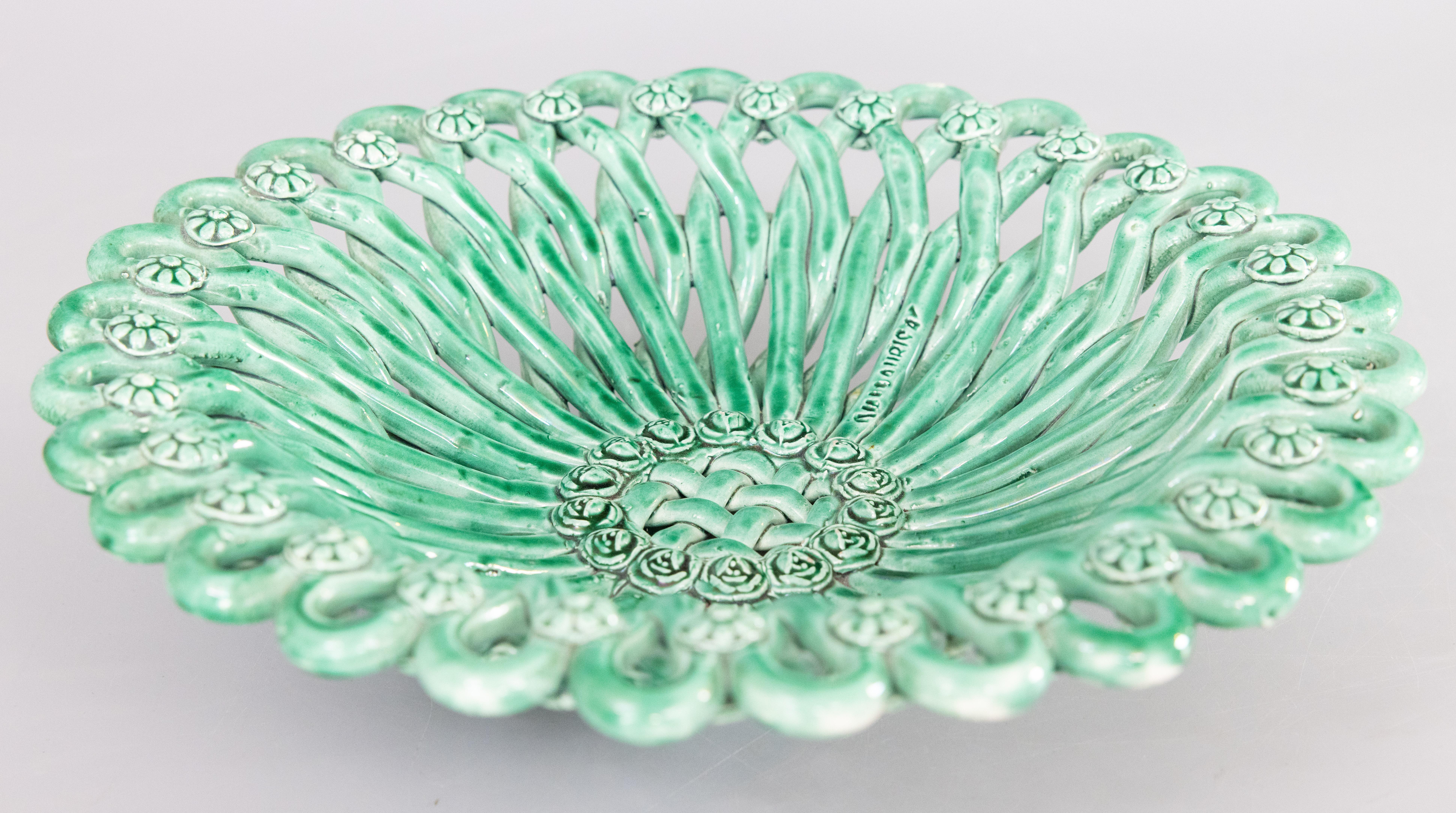 A gorgeous vintage majolica glazed green reticulated basketweave bowl from Vallauris in the French Riviera region of France, circa 1940. Maker's mark on interior. Vallauris is considered the capital of French pottery and is often referred to as the