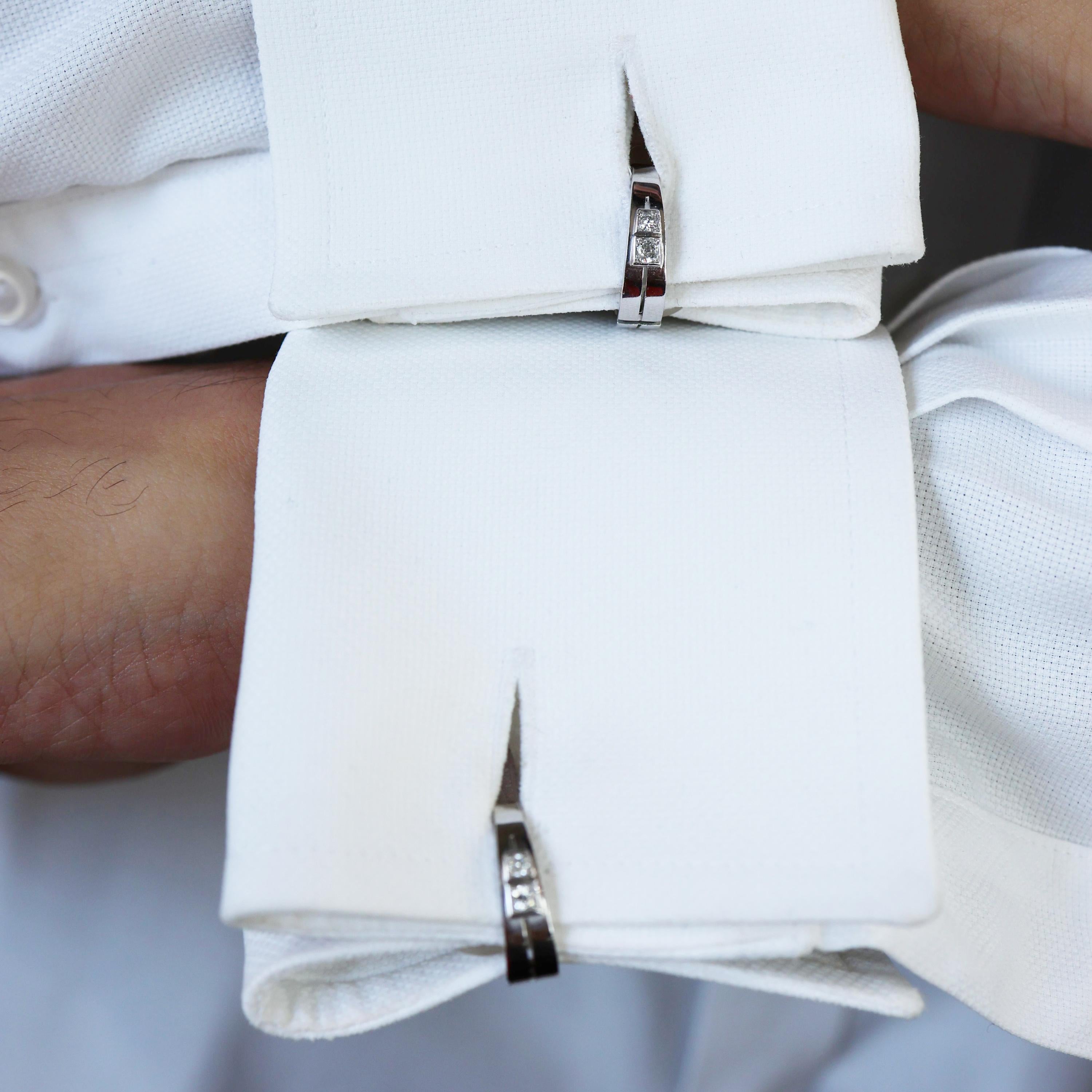 A pair of French, Van Cleef & Arpels diamond, platinum and 18ct white gold stirrup cufflinks, with two round brilliant or Edwardian-cut diamonds, on each side, in grain box settings, onto polished platinum stirrups, with an air gap cut down the