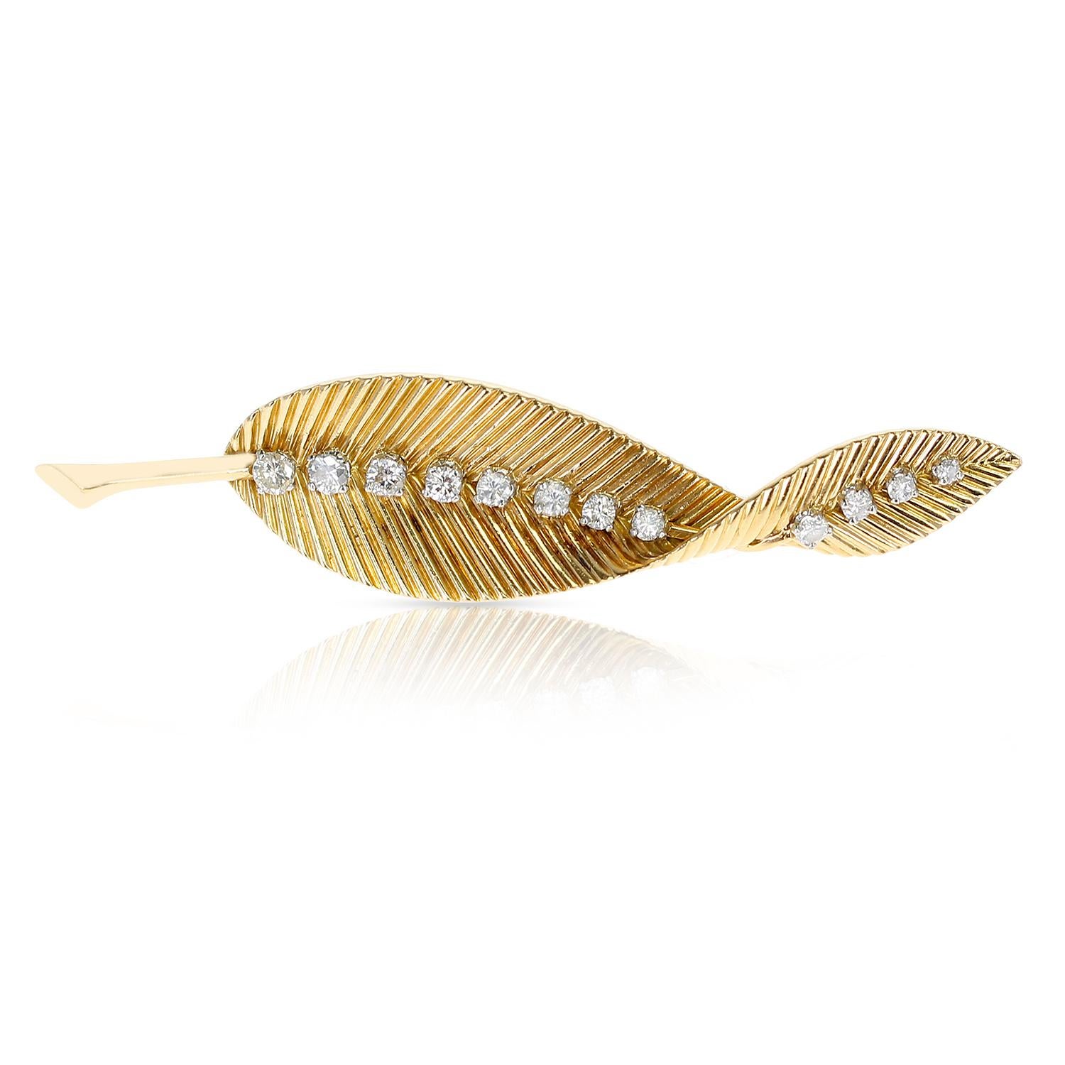 A French Van Cleef & Arpels Leaf Brooch Pin with 12 Round Diamonds made in 18 Karat Yellow Gold. The length is 3 Inches of the brooch. The total weight is 12.23 grams. Stamped MADE IN FRANCE. 
 