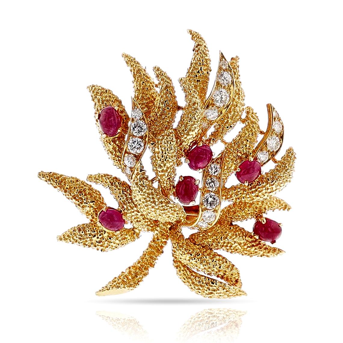 A Van Cleef & Arpels Péry et Fils Textured Gold, Diamond and Ruby Cabochon Brooch made in 18k yellow gold. The brooch weighs 23.57 grams, and the dimensions are 1.88 inches x 1.73 inches. The ruby cabochons weigh appx. 2 carats. Stamped made in