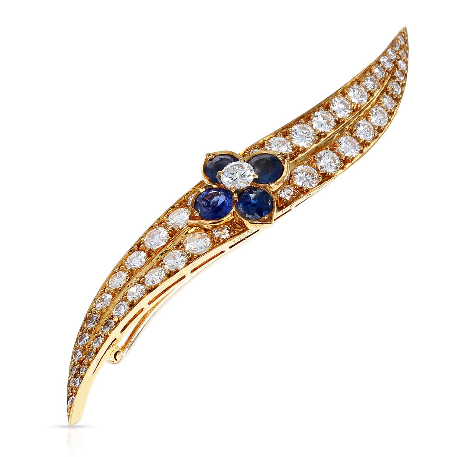 Van Cleef & Arpels Sapphire Floral and Diamond Pin made in 18 Karat Yellow Gold. Total Weight: 8.18 grams. Length: 2.50