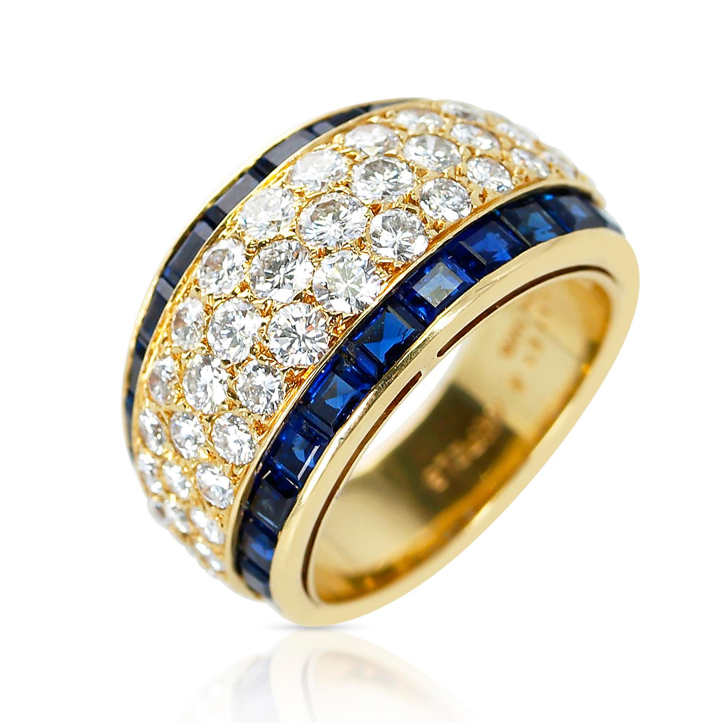 A Van Cleef & Arpels Three Row Diamond Ring with Invisibly Set Sapphires, made in France. 18 Karat Yellow Gold. Ring Size US 6. Total Weight: 9.37 grams. 