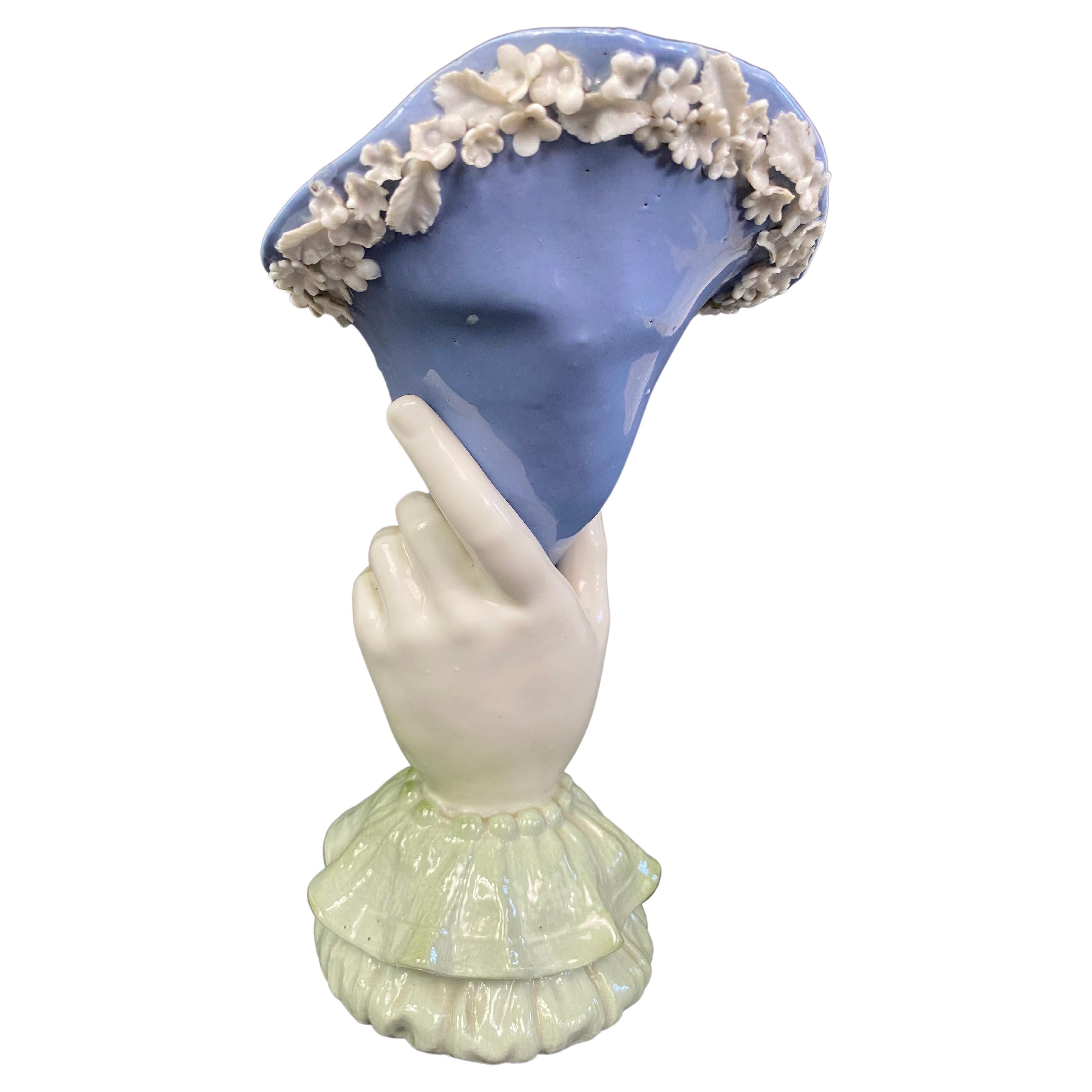 “Cornet” vase or “Main” vase late 19th century - early 20th century
Art Nouveau purple porcelain vase, representing a hand holding a cornucopia, white enameled flower cone
The opening is wavy and well flared.
The base represents the cuff of a lace