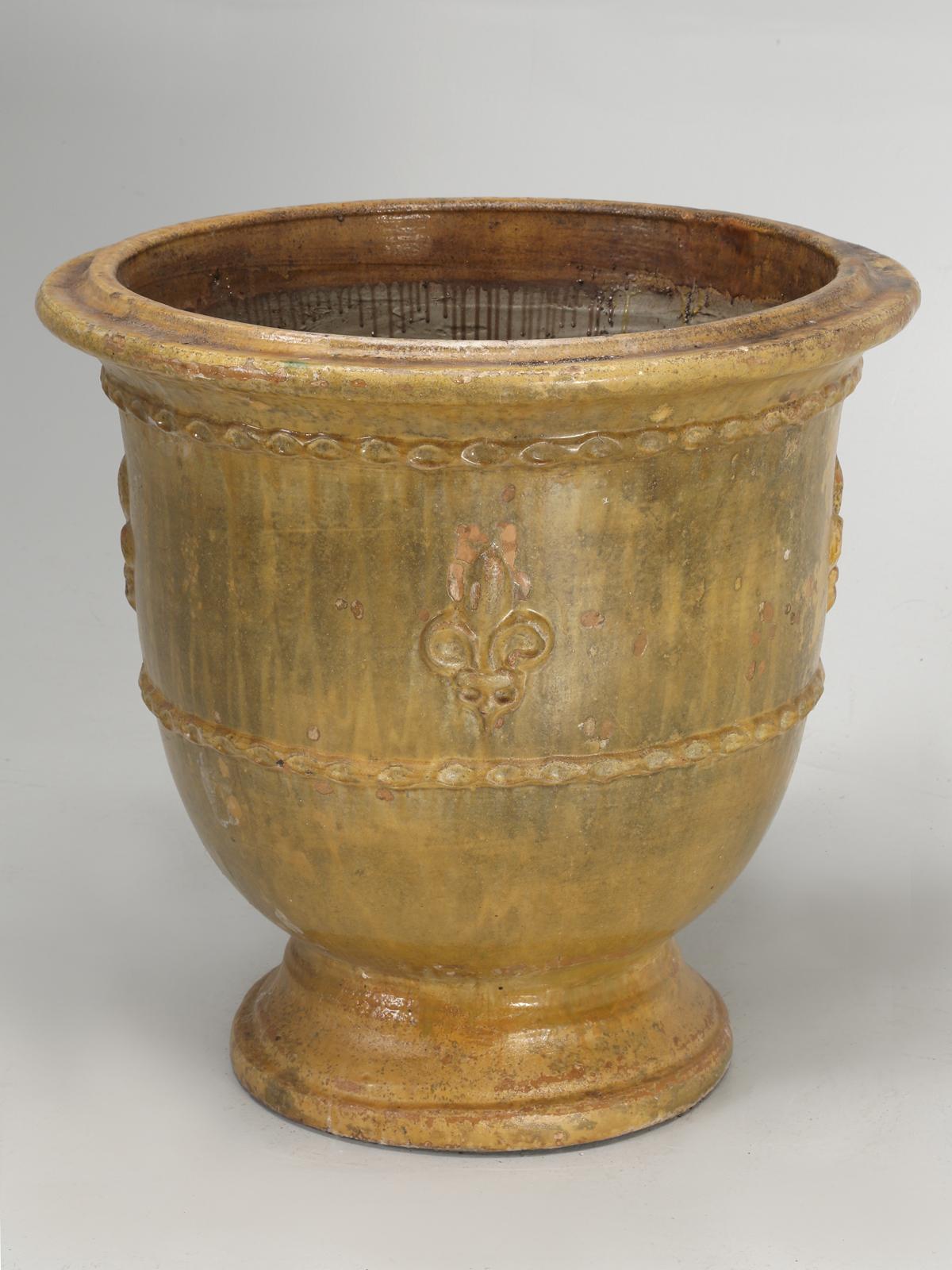 This particular vase or pot was produced by Poterie de la Madeleine in Anduze, France. This particular planter, has weathered many Chicago Winters and has been repaired over the years. This particular Anduze planter, has not been treated to a faux