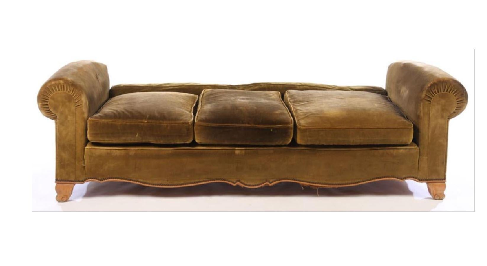 A gracefully designed daybed in the style of Andre Arbus, upholstered in French velvet, circa 1950. The daybed is designed with rolled arms, loose cushions and seat pillows and a curved apron and feet.