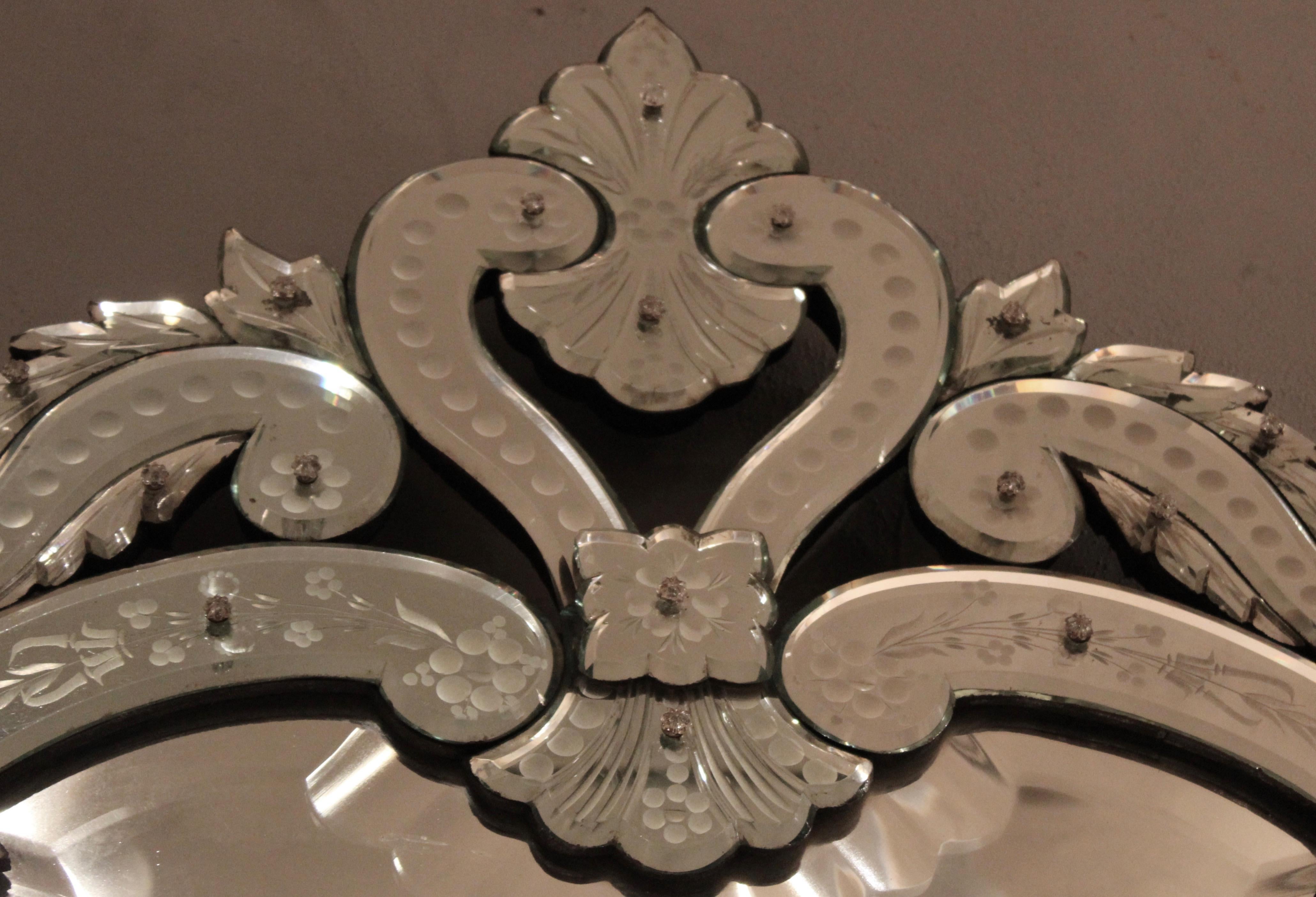 French Venetian style Rococo pier mirror, circa 1900. In a stylised arch shape, with a simple crest of etched glass scrolls and foliate motifs. The sides with a continuation of the etched floral motifs seen at the top. The mirror panels secured