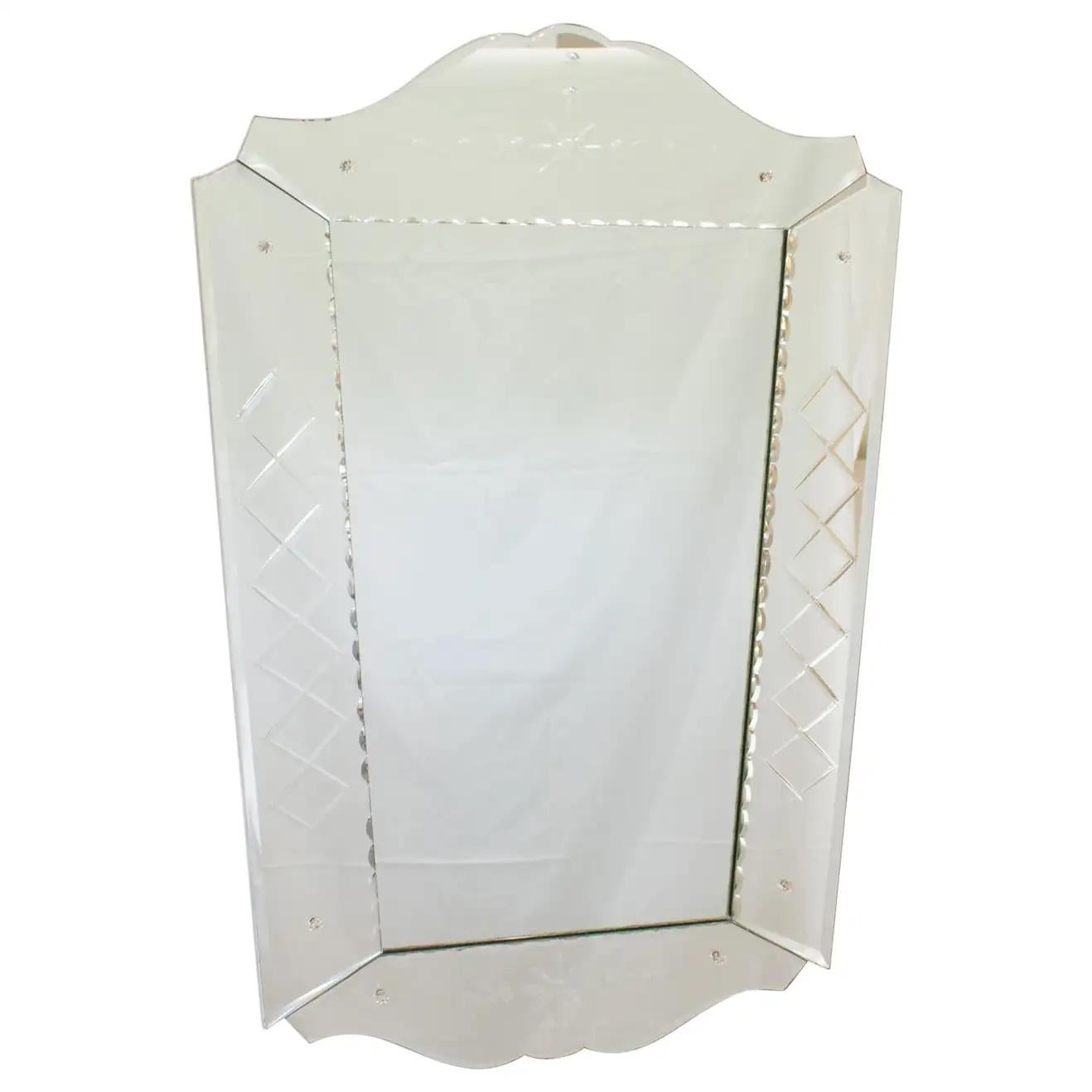 This elegant 1940s French wall mirror boasts a Venetian-style shape with beveled edges and a geometric etching design. The modernist flair and stylized design give versatility to this substantial mirror to fit in any room, from a boudoir to a