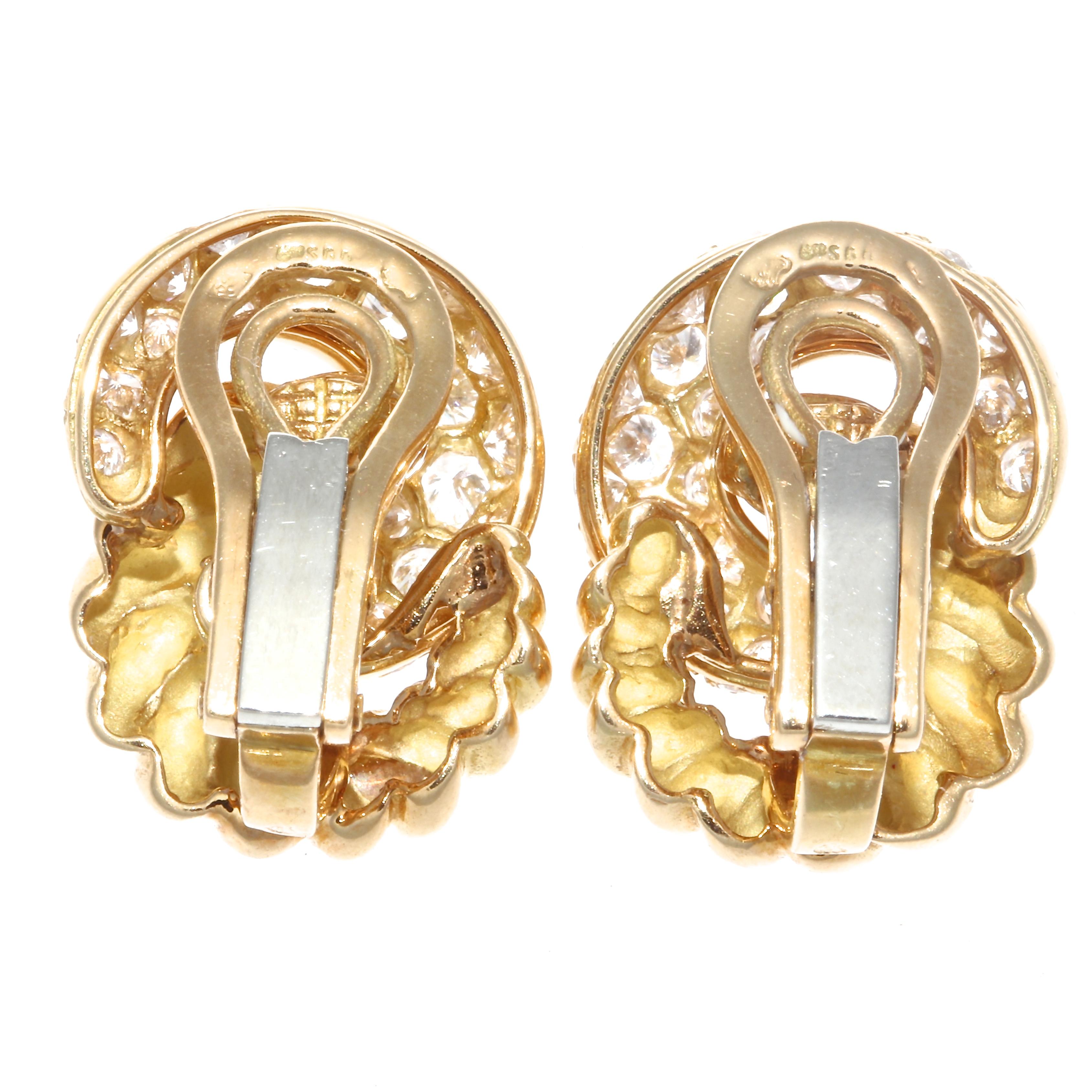 Elegant and classic double hoop earrings by Verdura featuring one twisted gold hoop and one diamond encrusted hoop. With 2.50 carats total weight in diamonds, graded D-E color, VS clarity. Stamped with French eagle head. Each earring is .5 inches