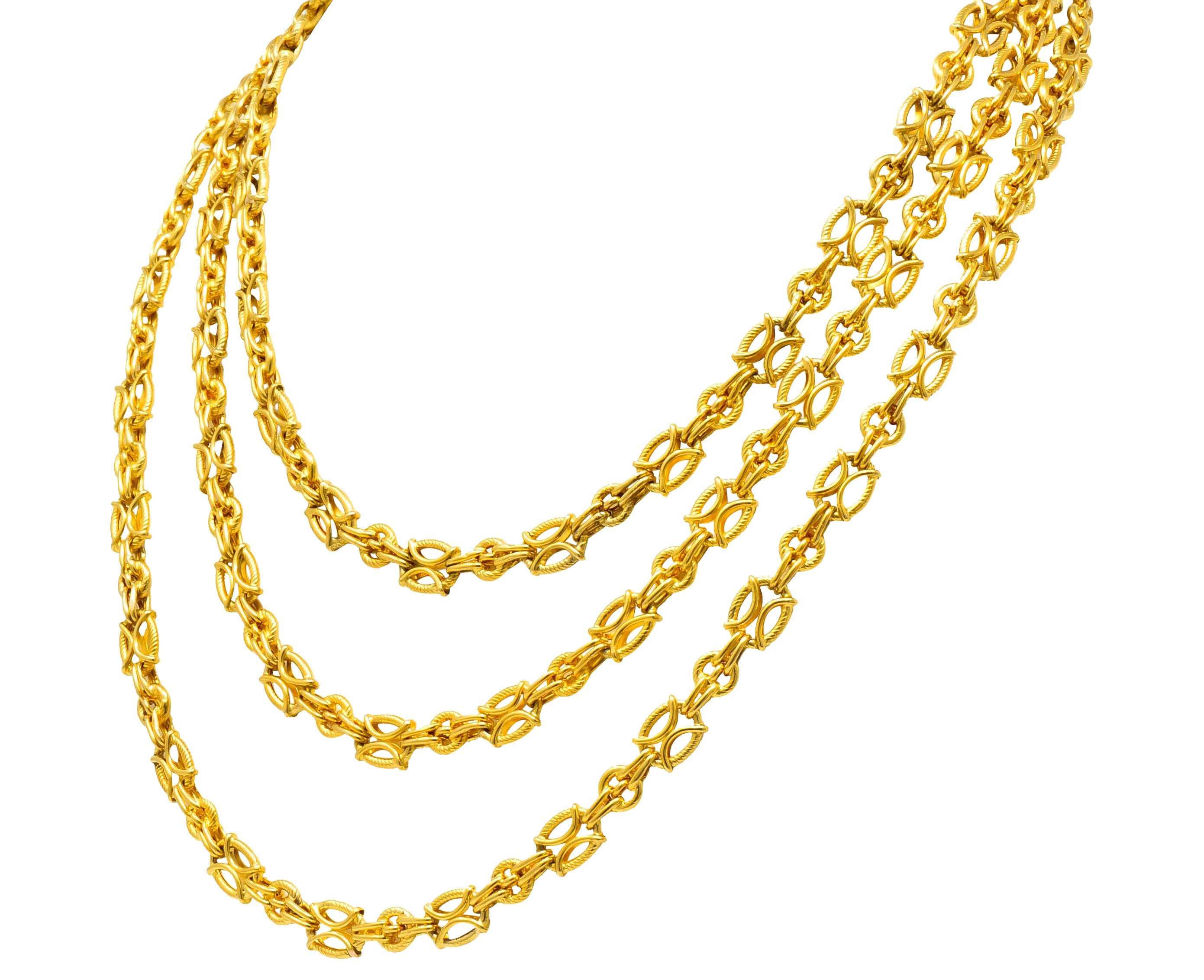 Necklace comprised of ribbed, oval links centering a polished gold hour glass motif alternating with smaller, round spacer links

Completed by spring ring clasp

Tested as 18 karat gold

Circa 1880's

Length: 53 inches

Width: 5/16 inch

Total