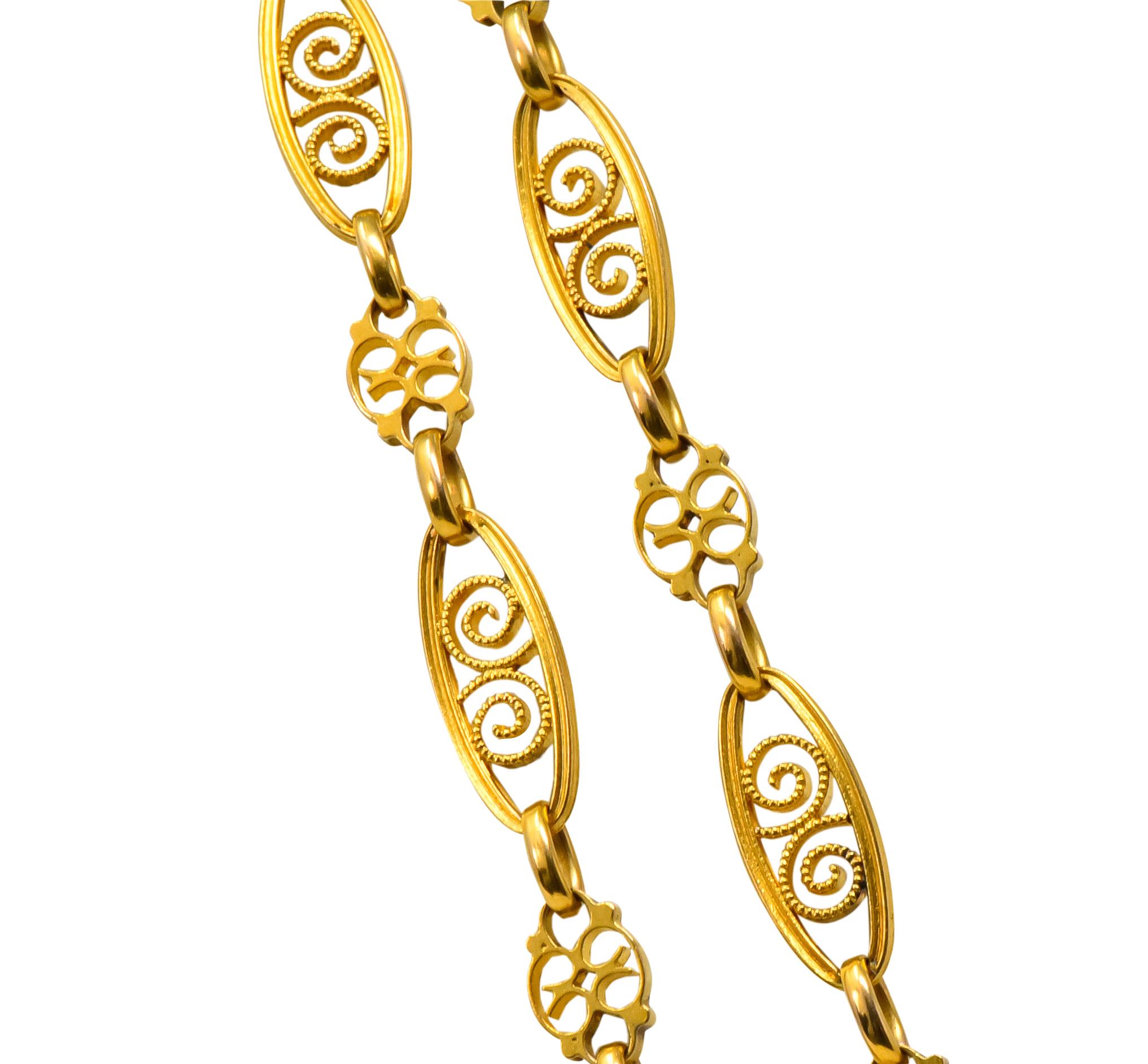 Fancy chain featuring pierced elongated links with swirled millegrain motifs and smaller alternating scrolled links

Completed by large spring ring clasp

Partial maker's mark with French assay marks for 18 karat gold

Circa 1840's

Length: 62
