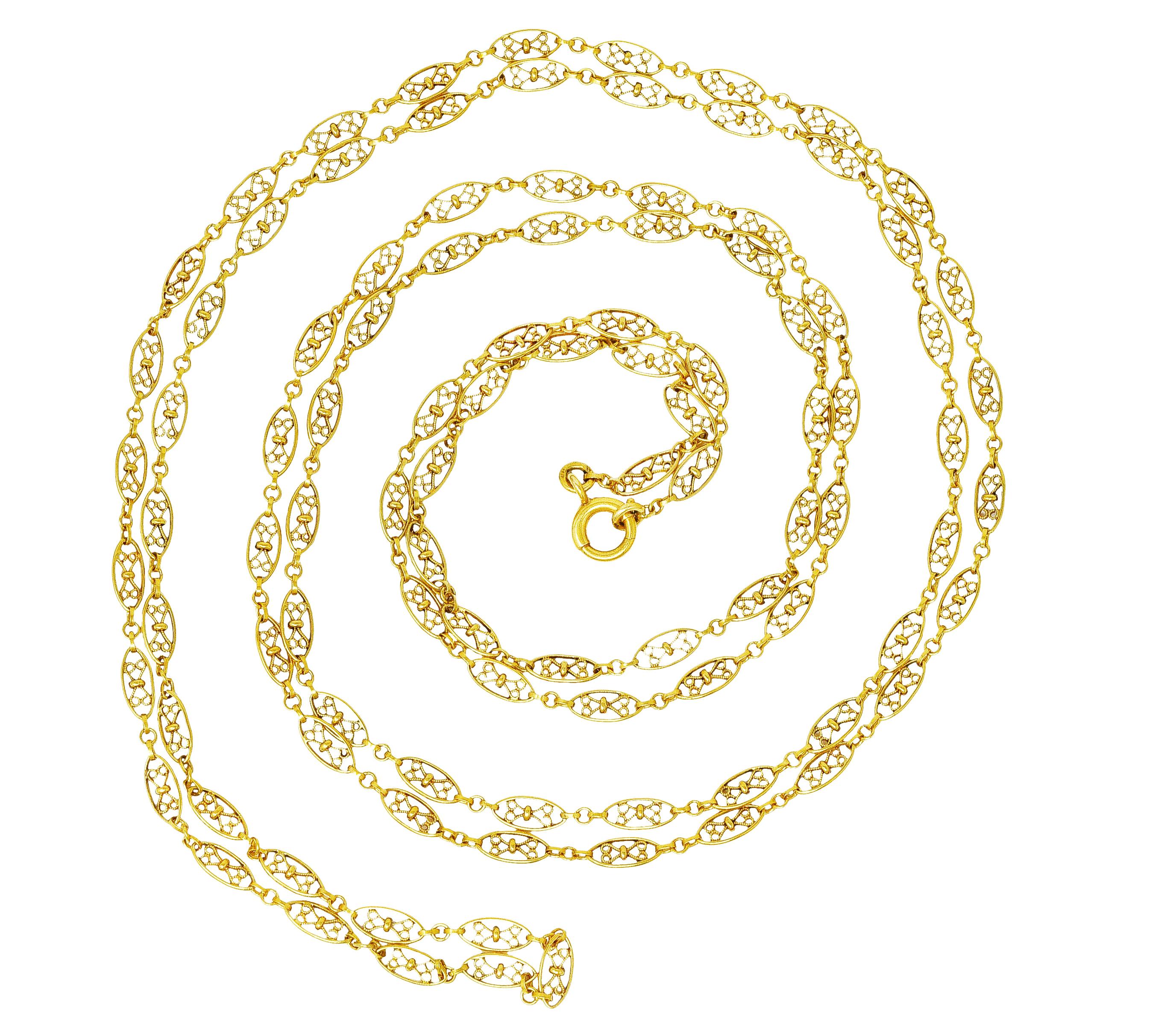 Necklace is comprised of navette shaped links connected by round jump rings. Centering scrolling heart motif filigree. Completed by spring clasp closure. Stamped with French hallmarks for 18 karat gold. With maker's mark. Circa: 1860's. Length: 60