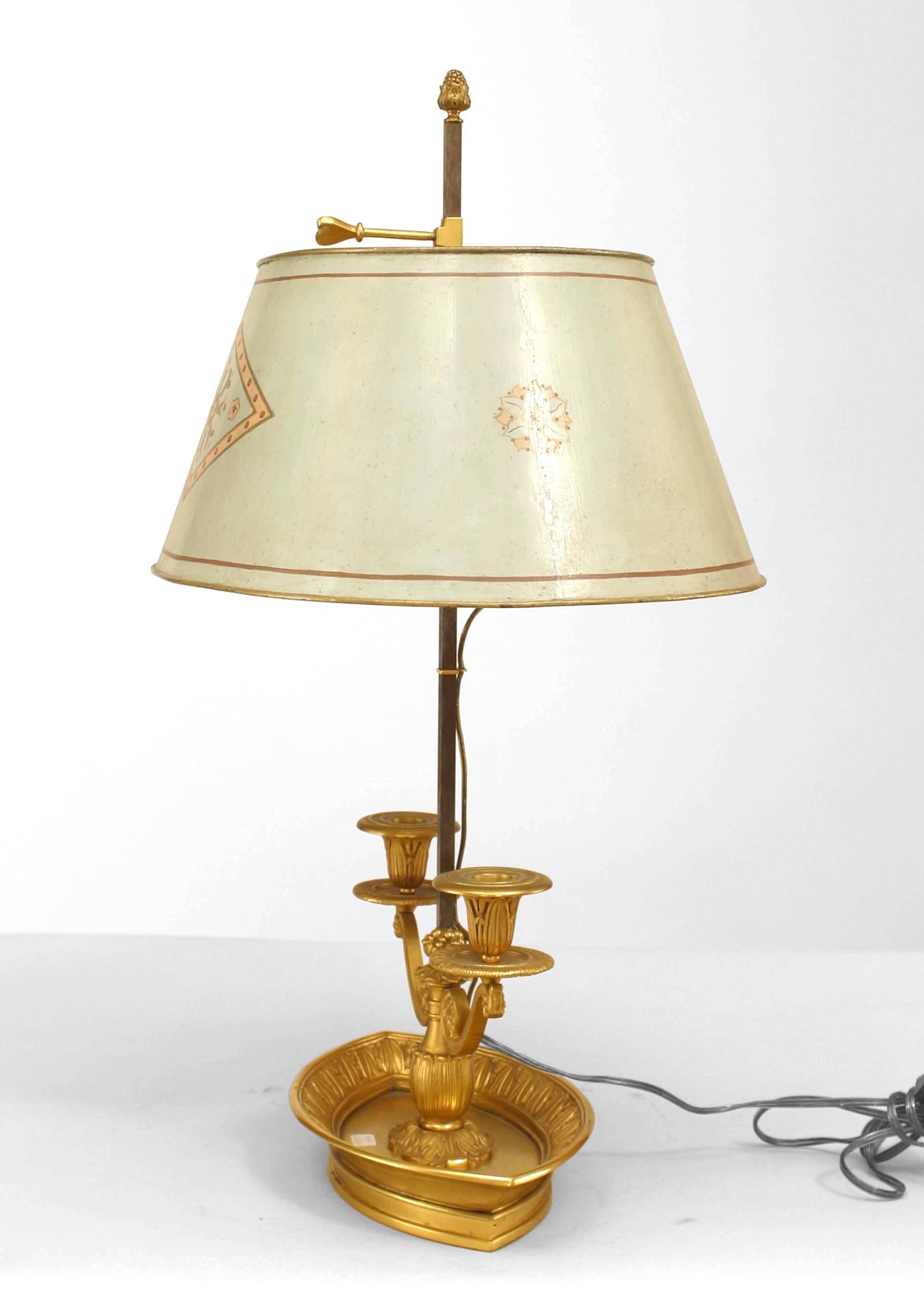 French Victorian (19th Century) gilt bronze bouillotte lamp with oval diamond form tray base and foliate detail supporting two scrolling arms with grey painted and decorated tole shade.
 
