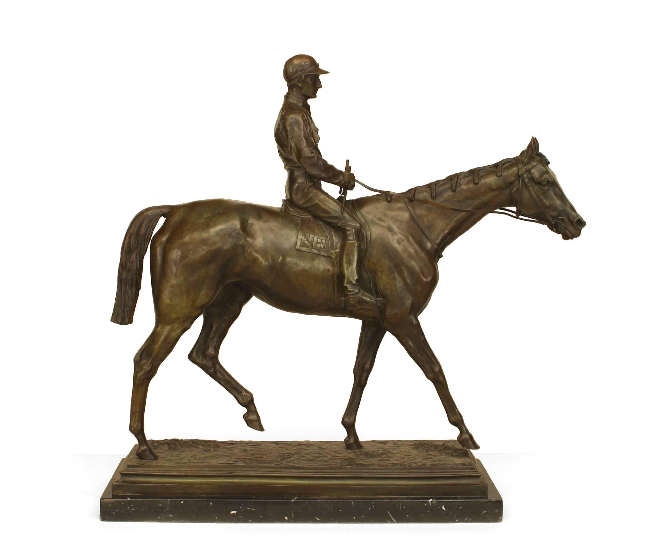 French Victorian (19th century) large bronze figure of a jockey astride a walking horse supported on a black marble base (signed: I BONHOUR).
 