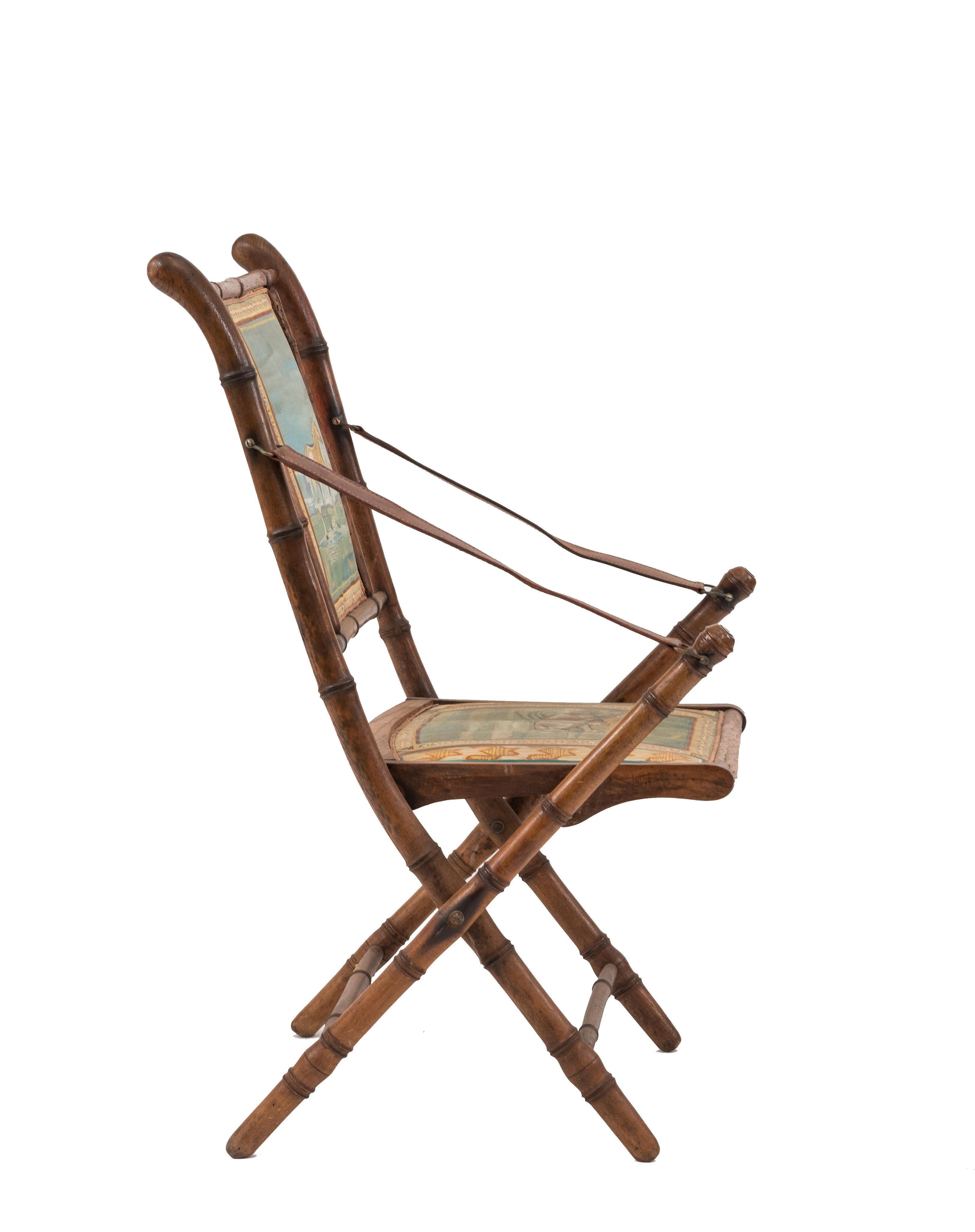 French Victorian oak faux bamboo Campaign design folding armchairhaving modern painted seat and back panels with animals and leather arm straps.