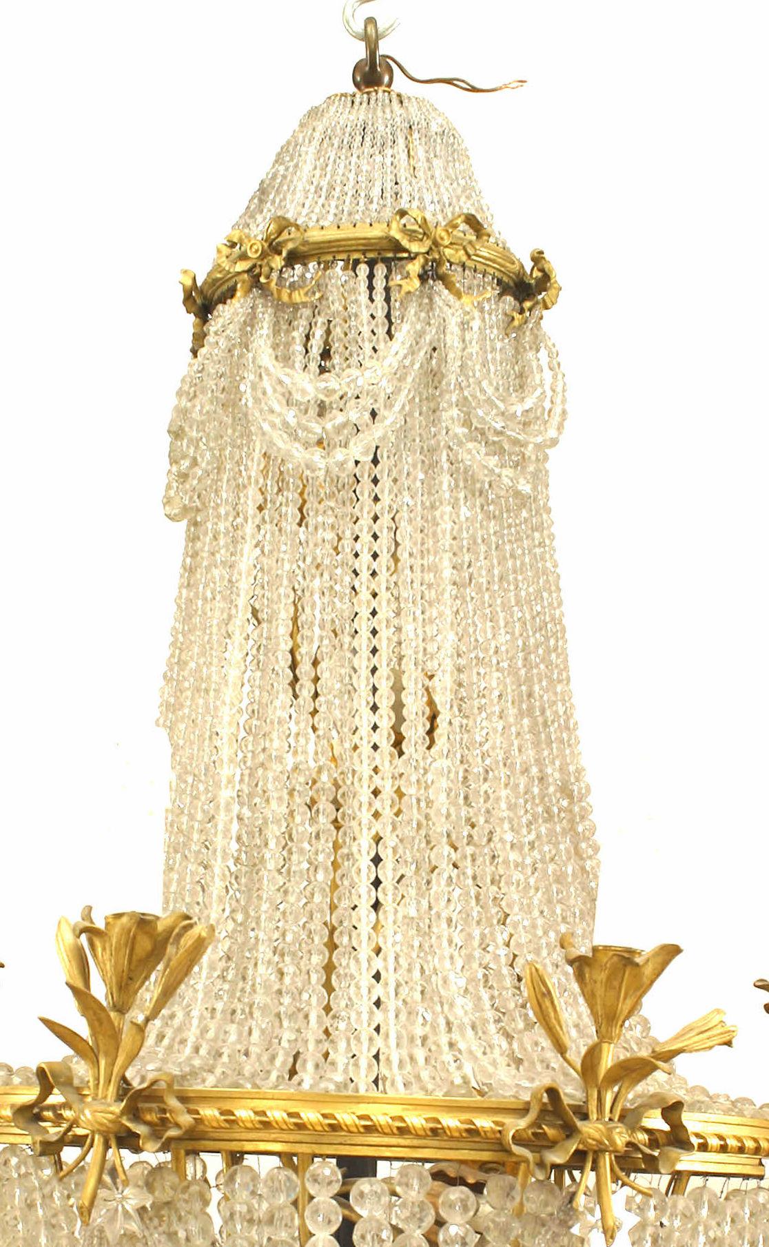 Lampadario di cristallo con perline in stile vittoriano francese (inizio del XX secolo) con un anello di 6 luci con disegno floreale in bronzo e nodi a fiocco e un anello superiore di nodi a fiocco con fasce di cristalli con perline.
