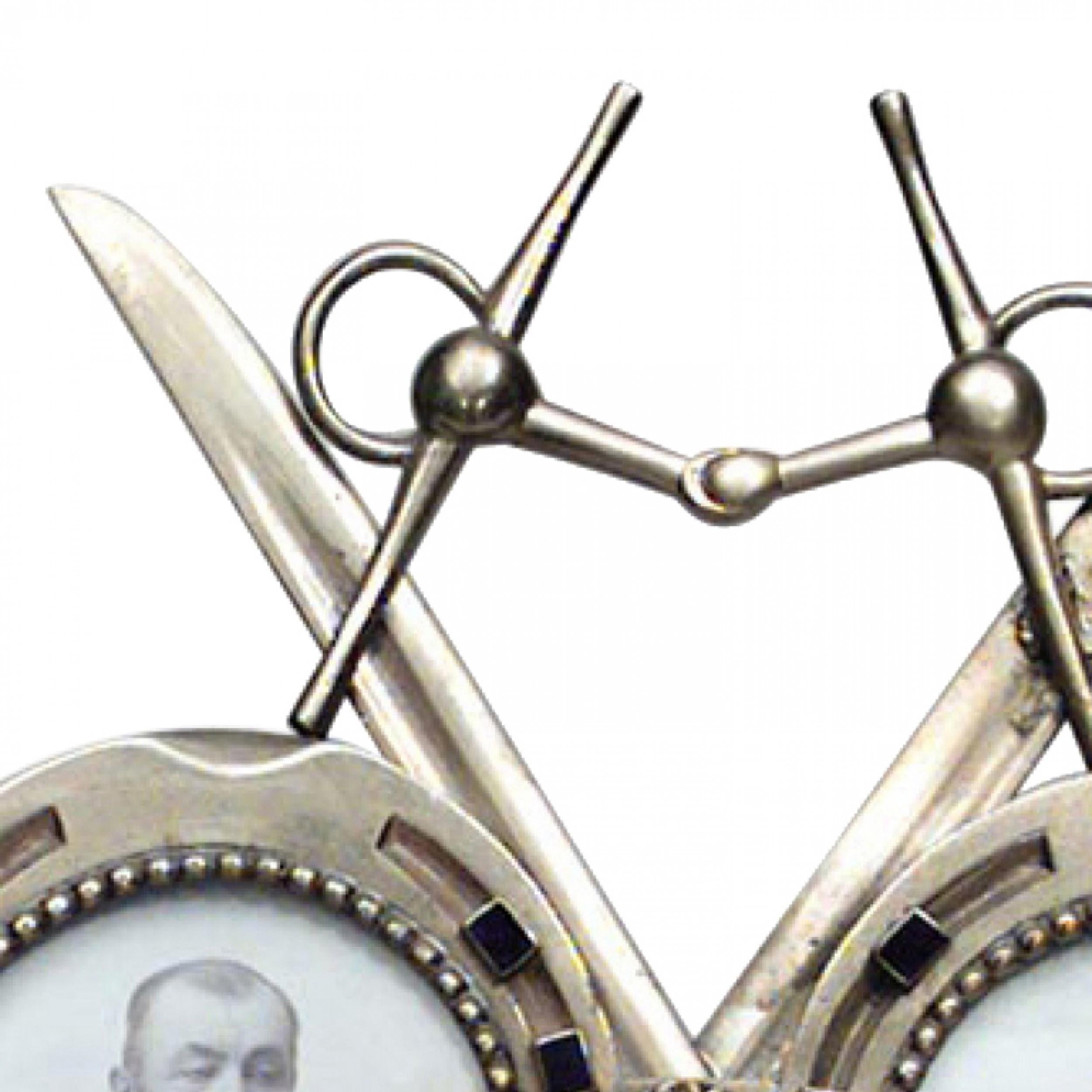 French Victorian enamel and brass easel picture frame of two horse shoes with crossed swords.