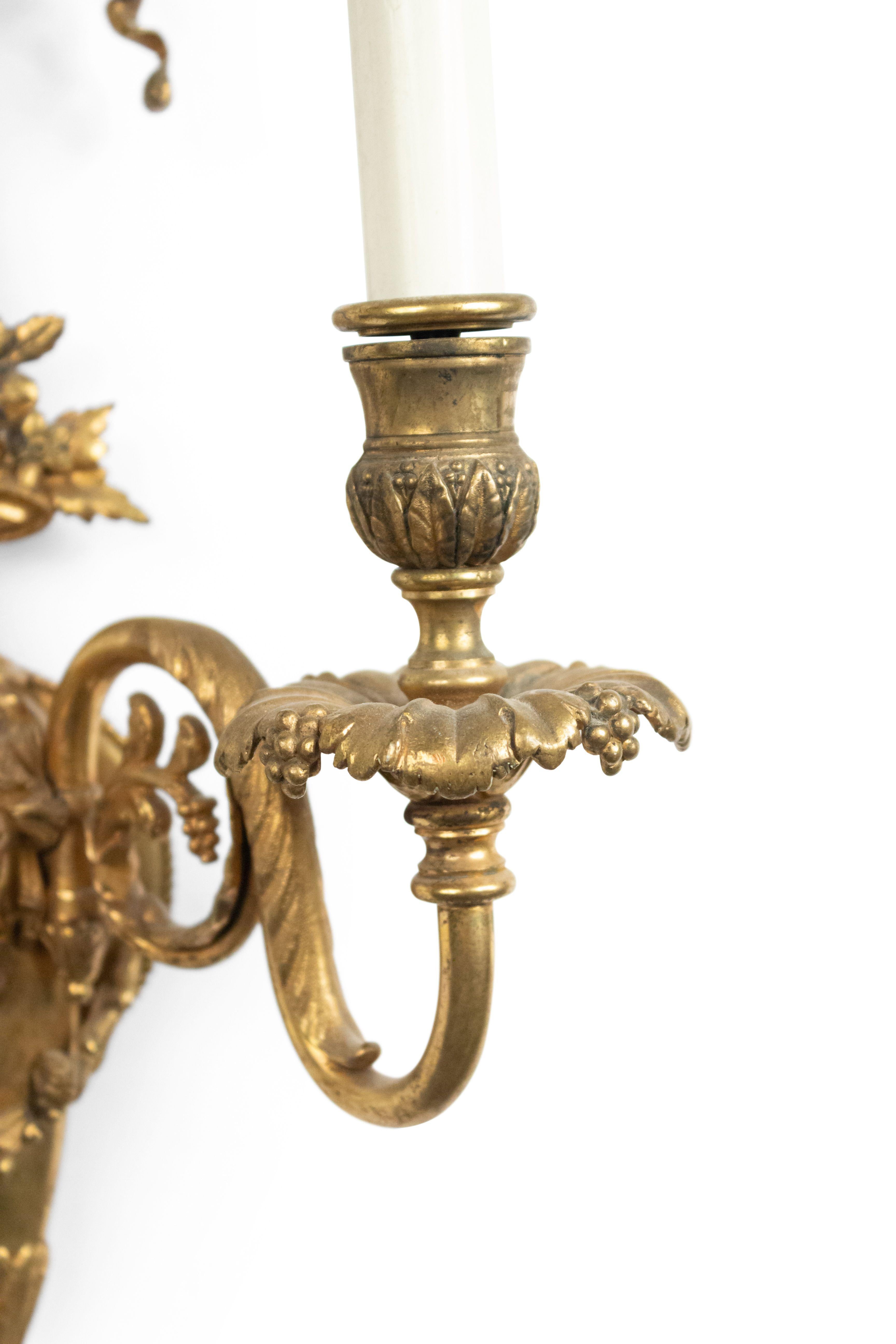 Pair of French Victorian style bronze dore 2 scroll arm wall sconces with lady's head and grape and floral design under bow knot top (19th-20th century).