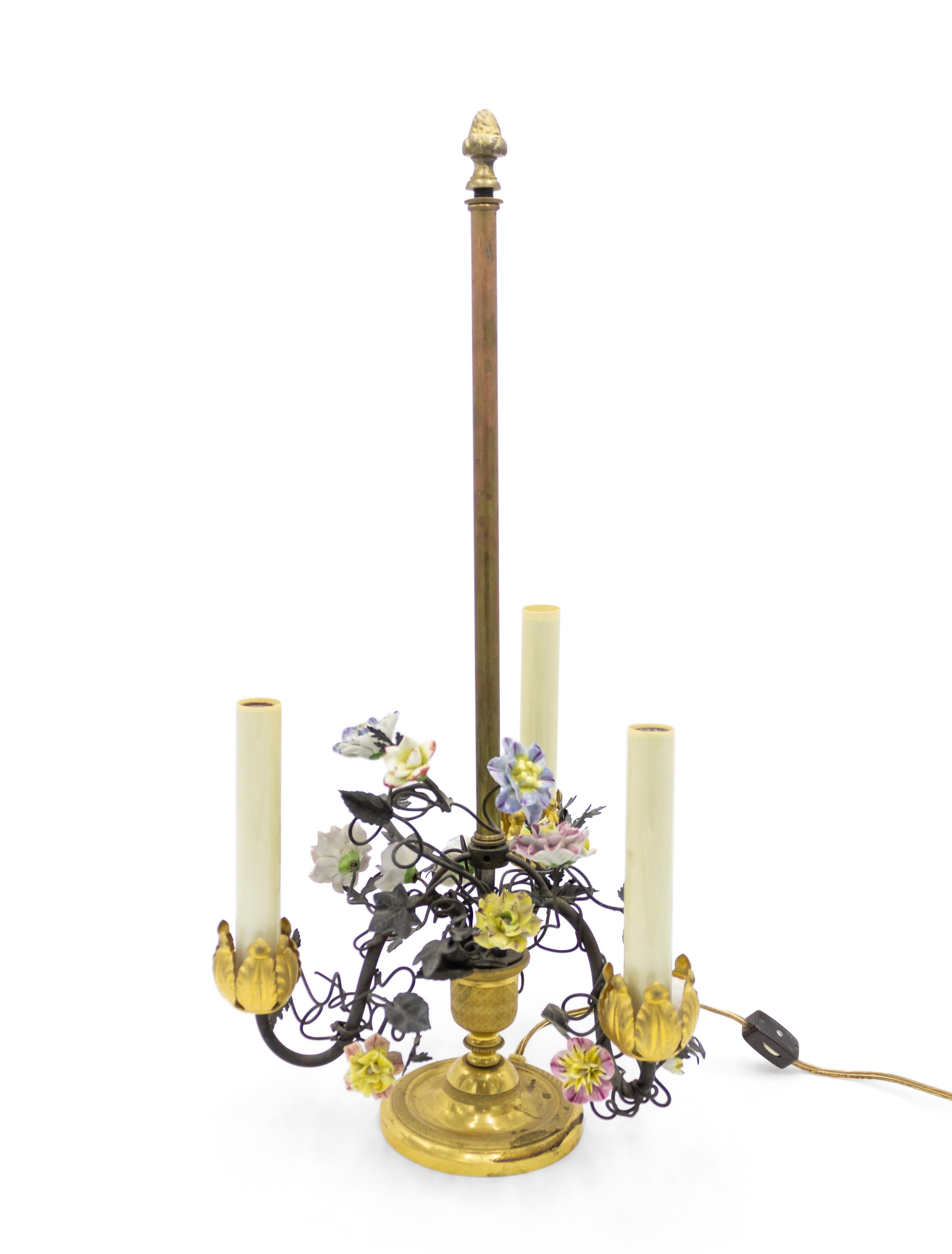 Pair of French Victorian 19th-20th century three-light lamps with metal foliate arms and porcelain flowers on a round bronze base.
