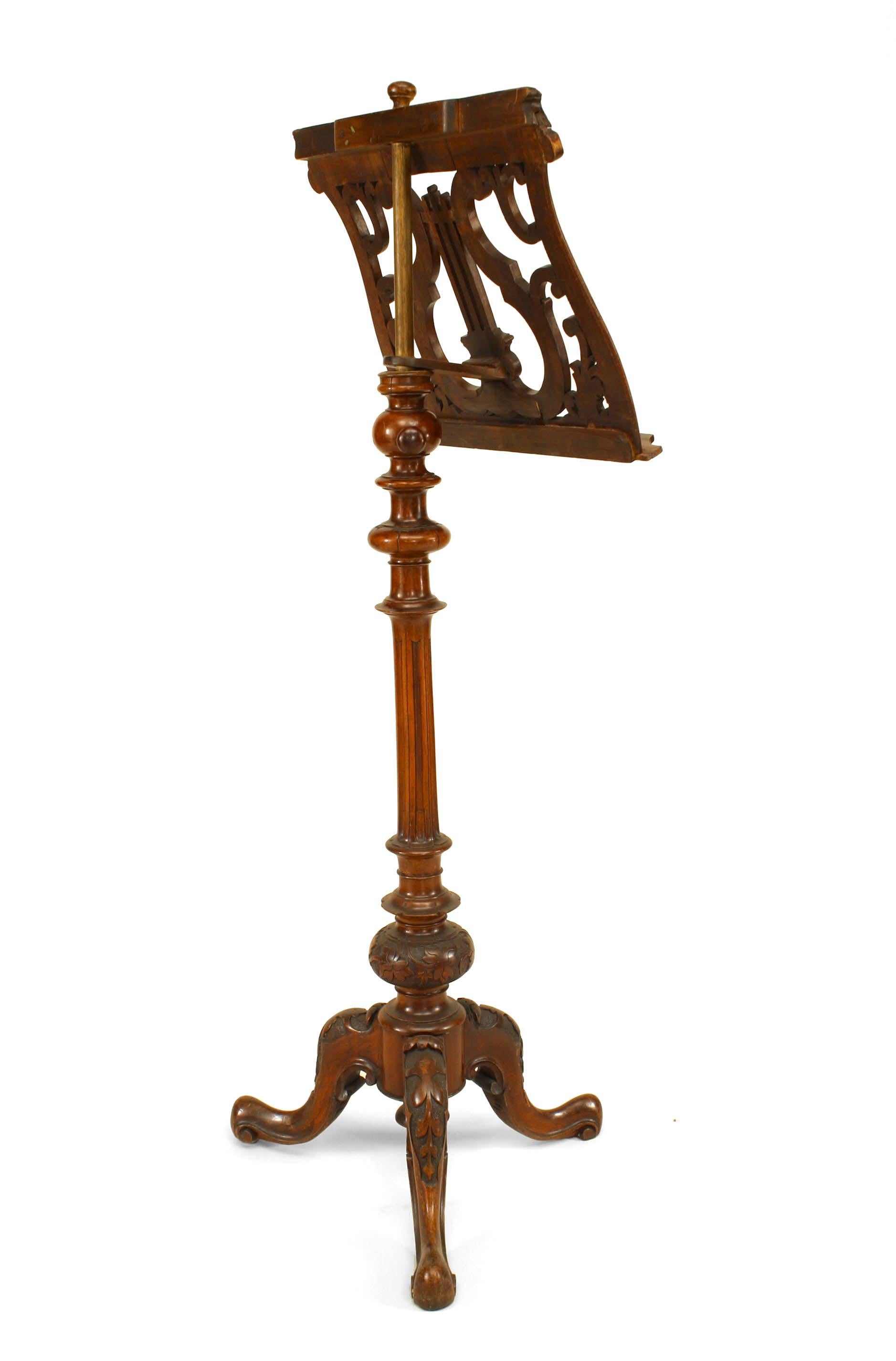 French Victorian carved walnut and filigree lyre top adjustable music stand with fluted acanthus leaf base.
