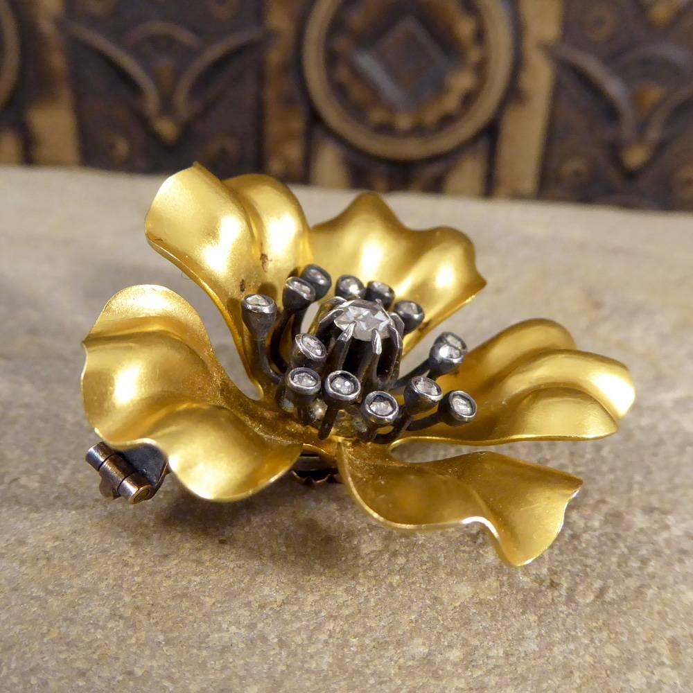 This gorgeous French antique brooch has been hand crafted in 18ct Yellow Gold showing curves and bends in the gold to resemble a flowers head. Set with Rose Cut Diamonds in the centre of the flower posing as the stamen and stigma created in Silver.