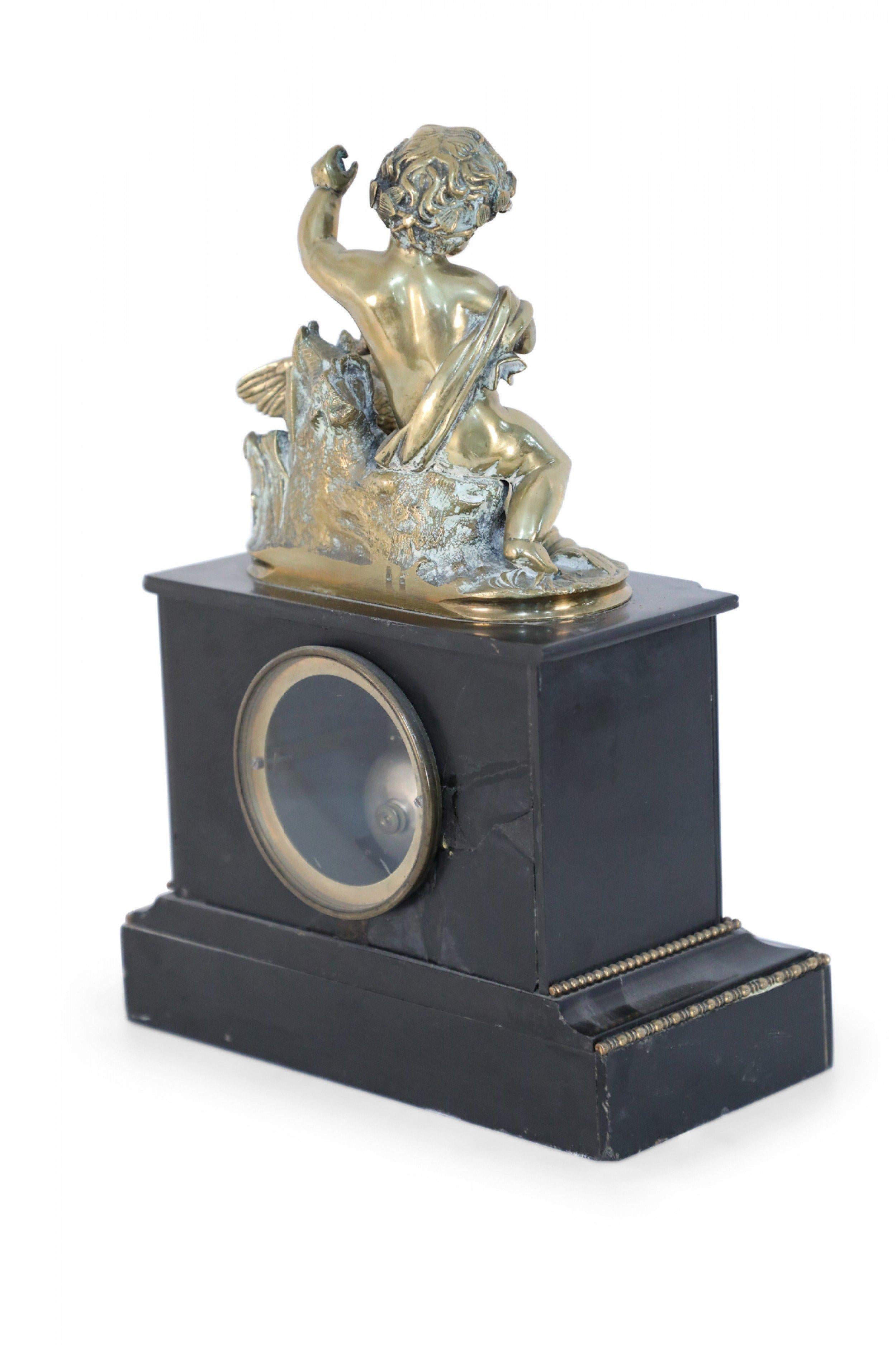 French Victorian style ebonized mantle clock with bronze putti and swan supported on a weighted ebony base with encased dial and beaded gold trim.