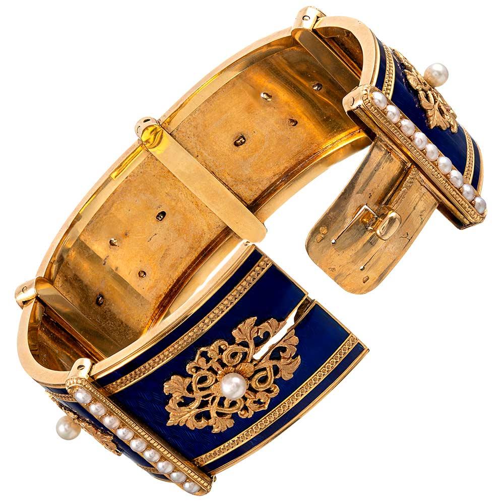 Impeccably preserved and created with exceptional skill, this Victorian adornment will delight the most discerning of antique enthusiasts. Richly-hued cobalt blue enamel offers a dramatic backdrop for the 18 karat yellow gold decorations and natural