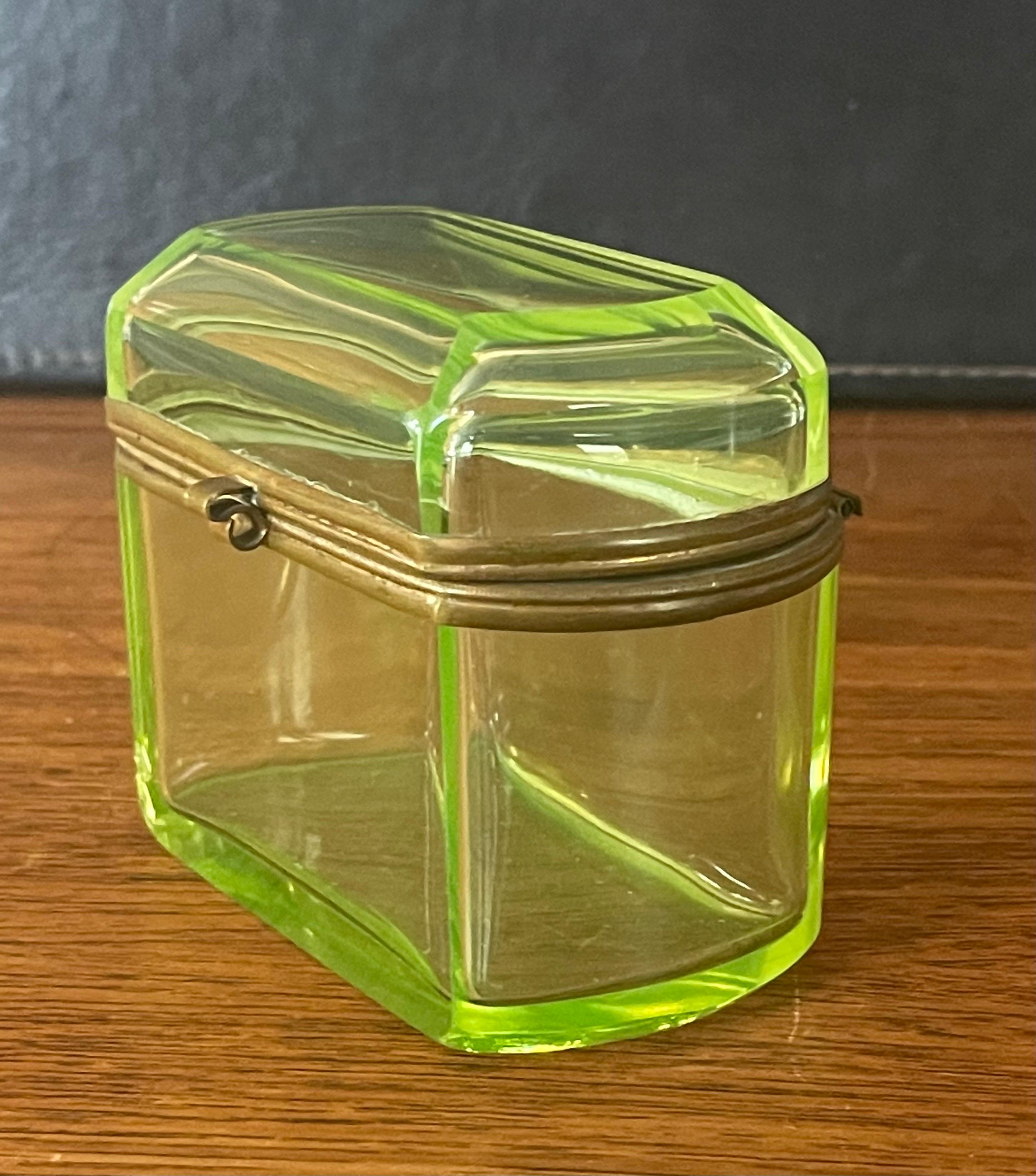 A fabulous French Victorian era vaseline colored glass lidded box, circa late 1800's. The box is made of a thick vaseline colored glass with bronze dore latch and trim. The piece is in very good antique condition with no chips or cracks and measures