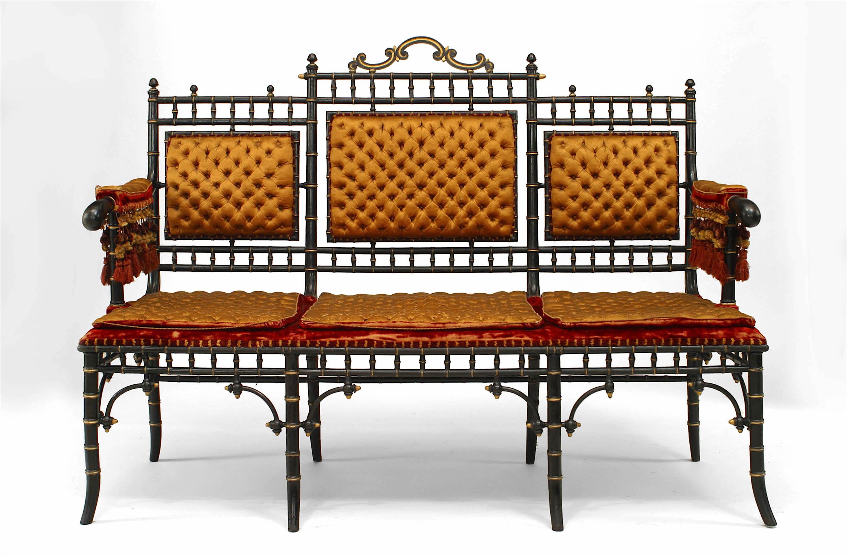 French Victorian faux-bamboo design ebonized and gilt-trimmed settee with tufted gold upholstery and fringe (matching stools: 052463)
