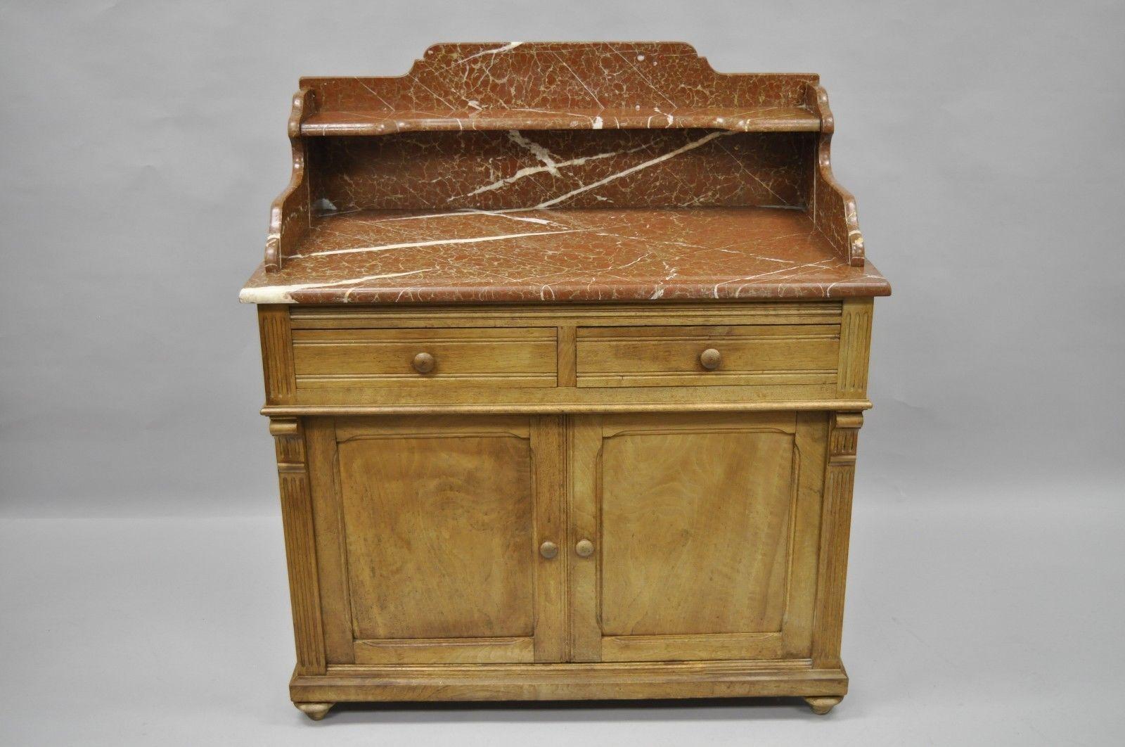 Antique Victorian marble-top commode. Item features beautiful tall earth tone marble back splash, two dovetailed drawer, lower storage cabinet doors, interior shelf, stunning overall form. Very rare marble and style, circa 1900, believed to be
