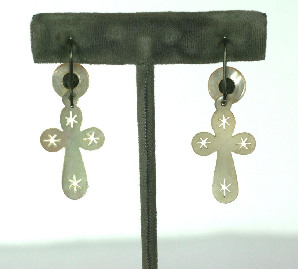 French Victorian hand carved mother of pearl crucifix drop earrings. The articulated drop earring of pierced and incised, carved mother of pearl fitted with silver metal french wire ear hooks.
Crucifix pendants can be removed. 1870's France.