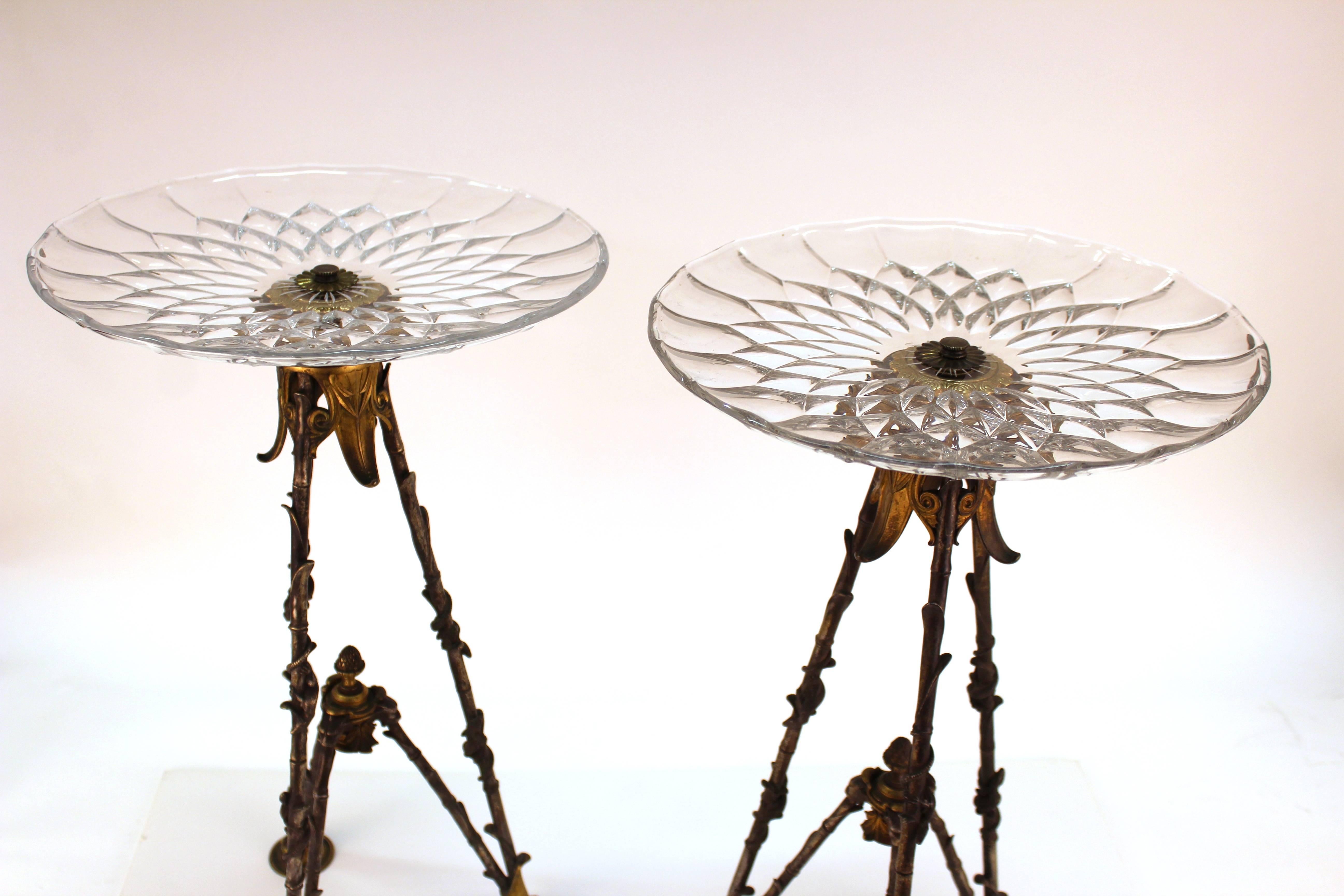 A pair of highly decorative French Victorian tall pastry holders with circular Val St. Lambert glass plates atop elaborate tripod bronze bases with sculptural naturalist details and salamanders. The pair dates back to the 1880s and was made in