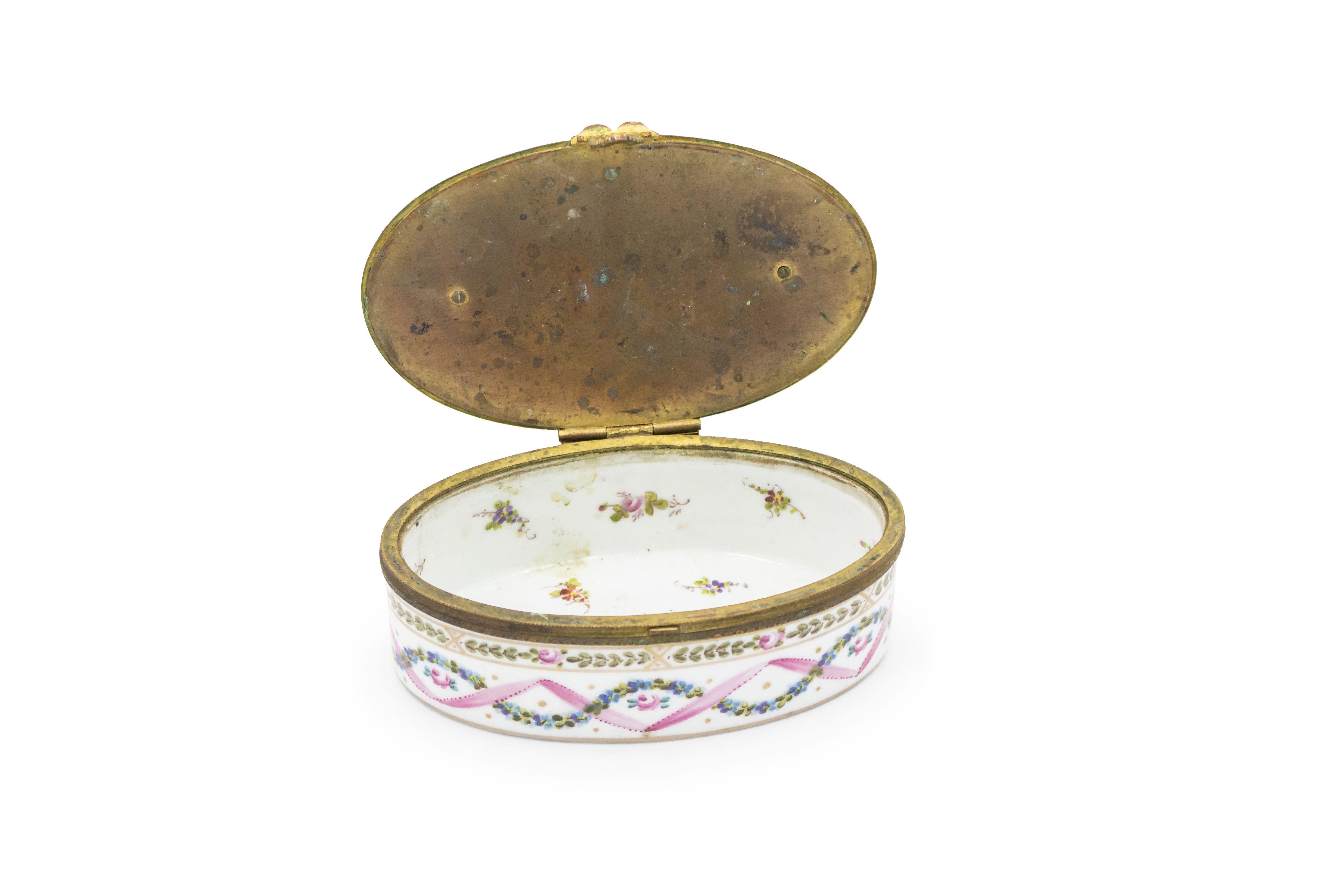 French Victorian (19th Cent) small porcelain Sevre oval box with bronze lid and pink & white decoration and interior with flowers (signed on bottom).
 