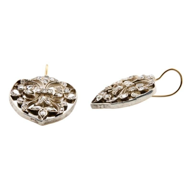 Aston Estate Jewelry Presents:

A pair of victorian period French hallmarked heart motif diamond earrings. Displaying beautiful hand wrought scroll work throughout complemented by diamond set flowers and leaves. Set with 76 rose cut diamonds of