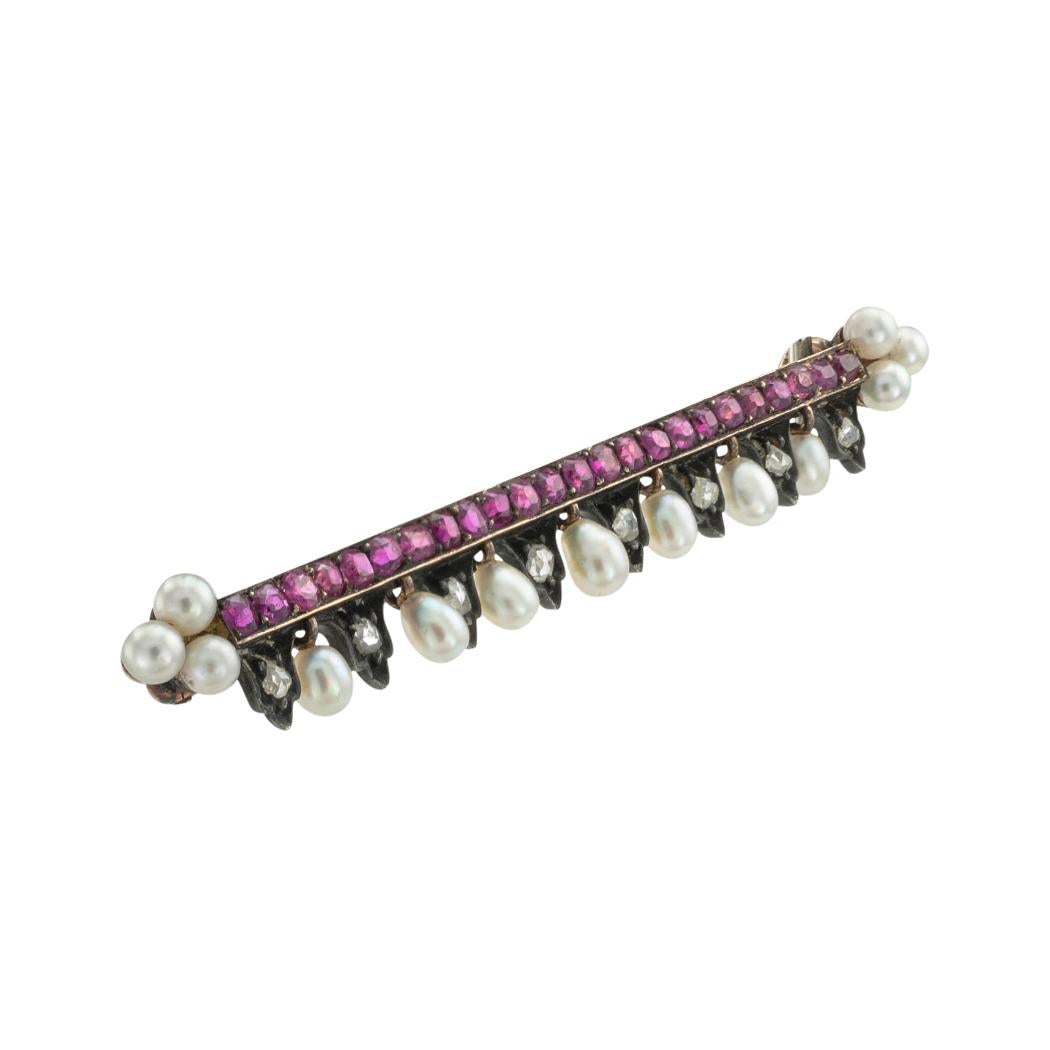 French Victorian ruby, pearl, and rose-cut diamond gold and silver bar brooch circa 1890. *
ABOUT THIS ITEM:P-DJ121i Scroll down for specific details. This captivating ruby bar brooch features baroque inspired design elements.  A course of rubies is