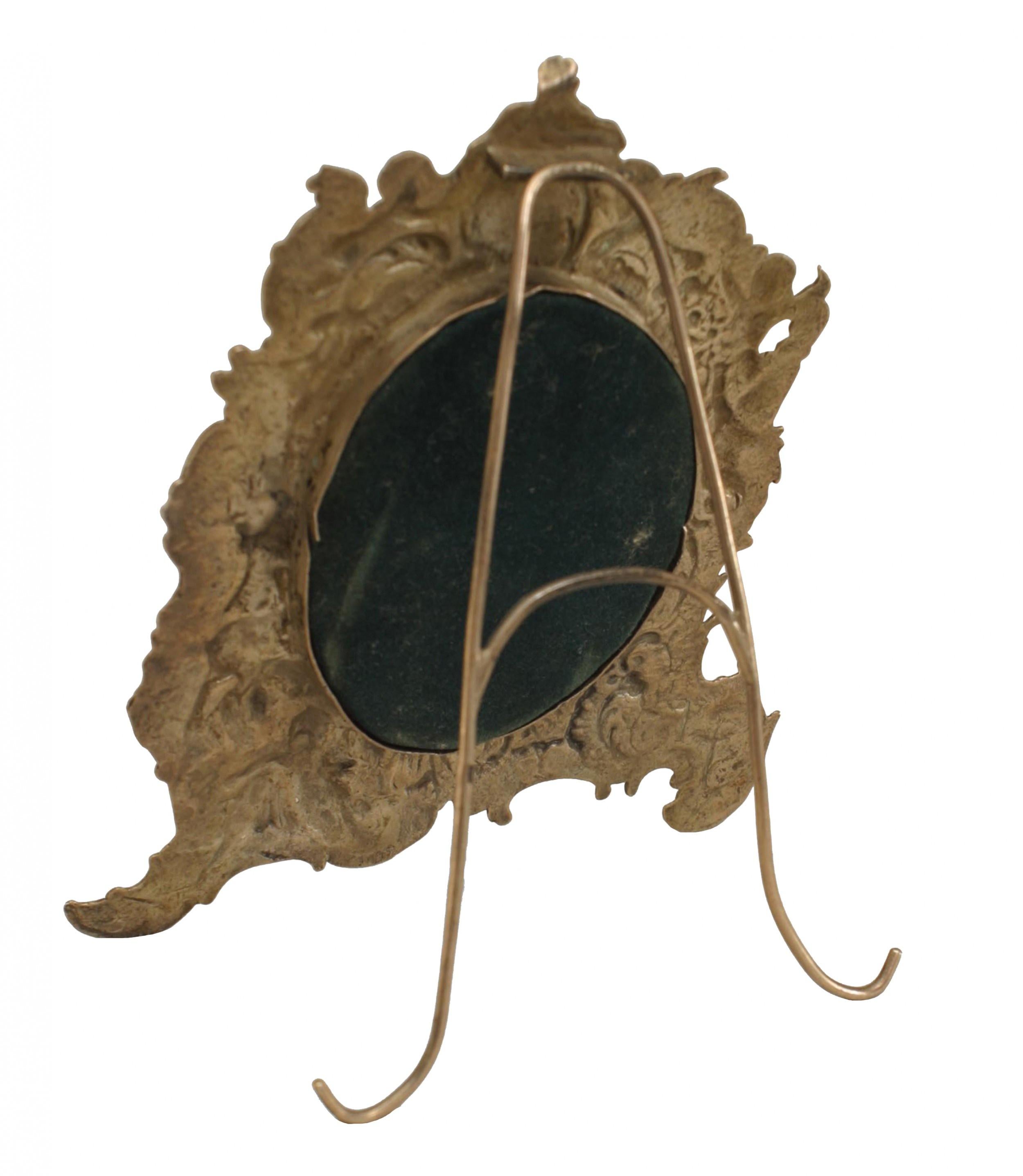 French Victorian sterling silver easel picture frame with embossed cupids and scroll design.