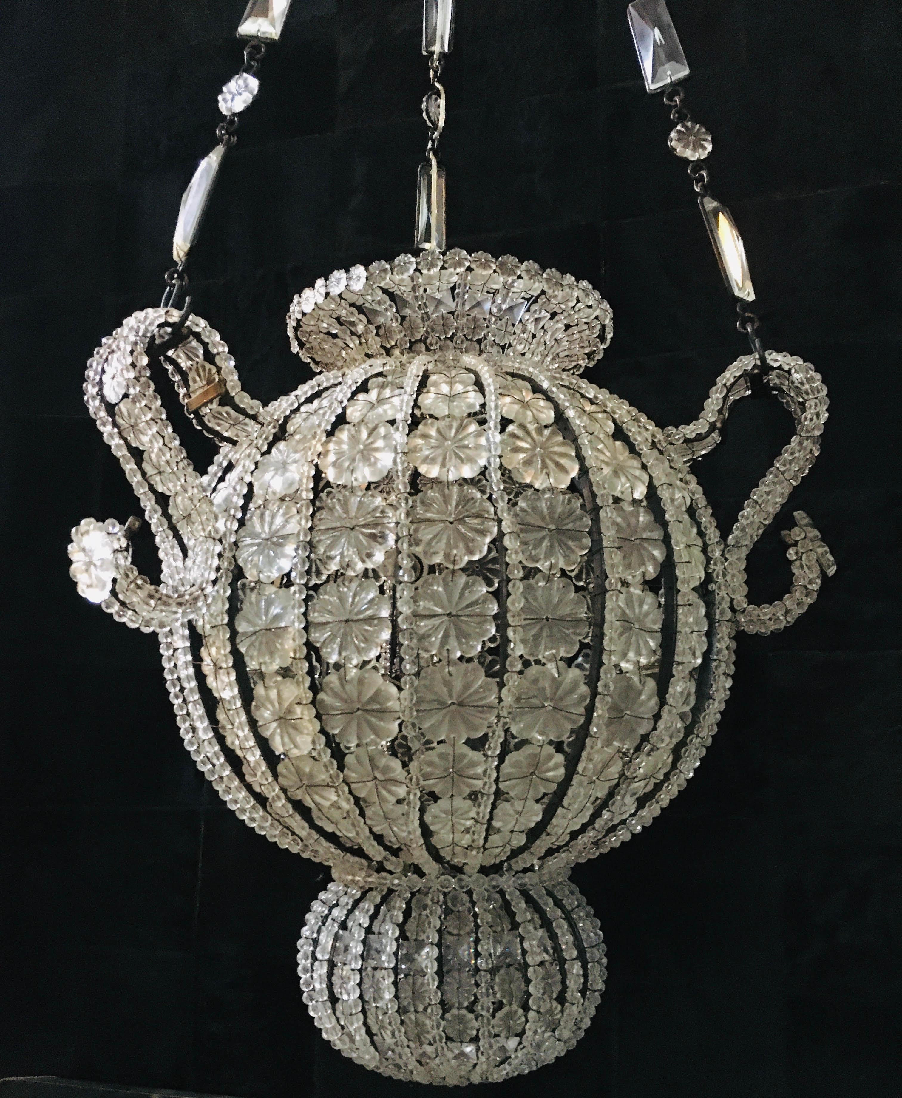 The vintage crystal beaded basket is hand-strung with hundreds of faceted crystals to reflect and refract the light and adds festive sparkle to every moment.

Number of Lights: 6.