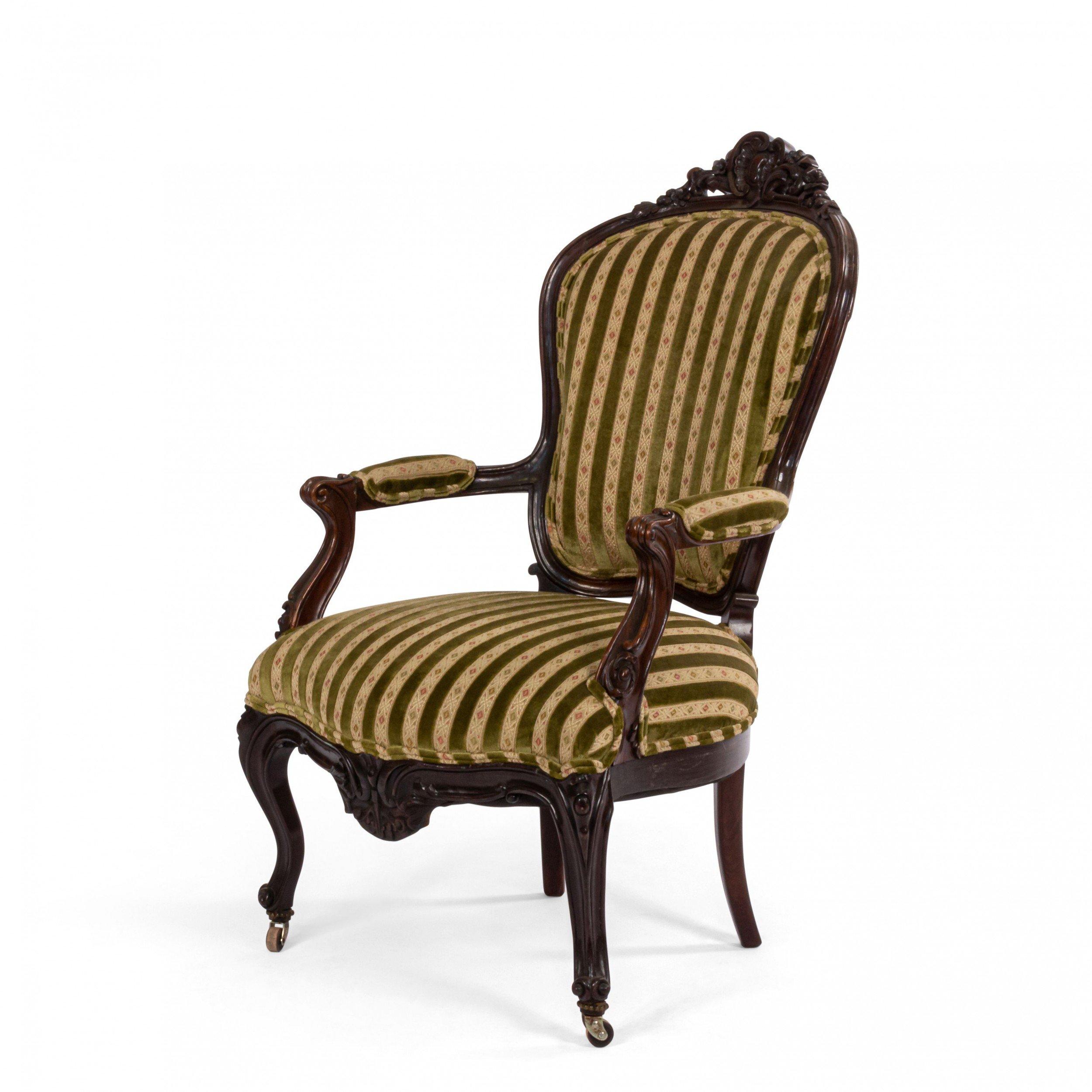 Pair of French Victorian rosewood armchairs with carved back crest rail and striped velvet upholstery
