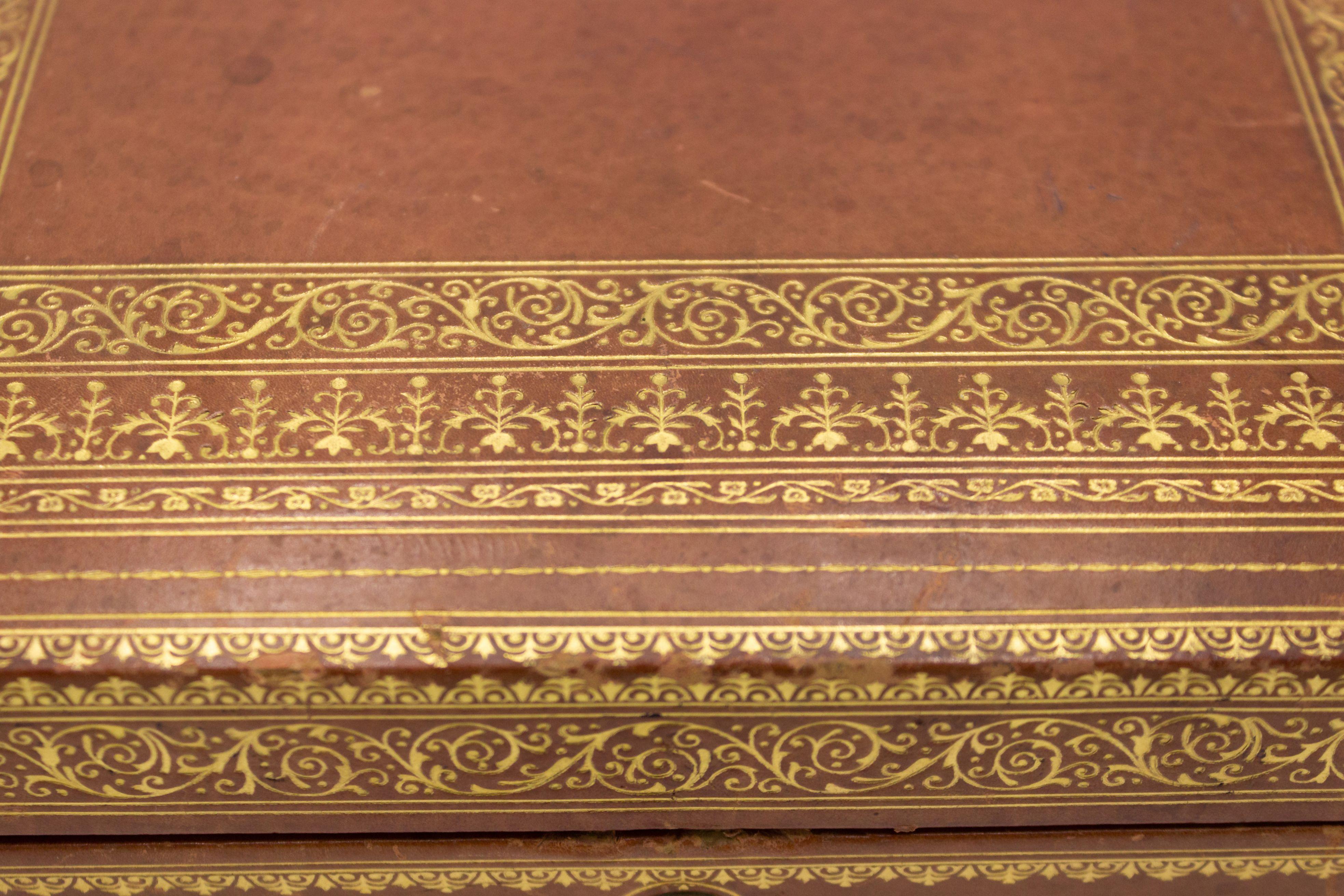 French Victorian-style rectangular brown tooled leather jewelry box with four compartments.
 