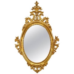 Miroir mural ovale de style victorien français en bois doré à volutes en filigrane